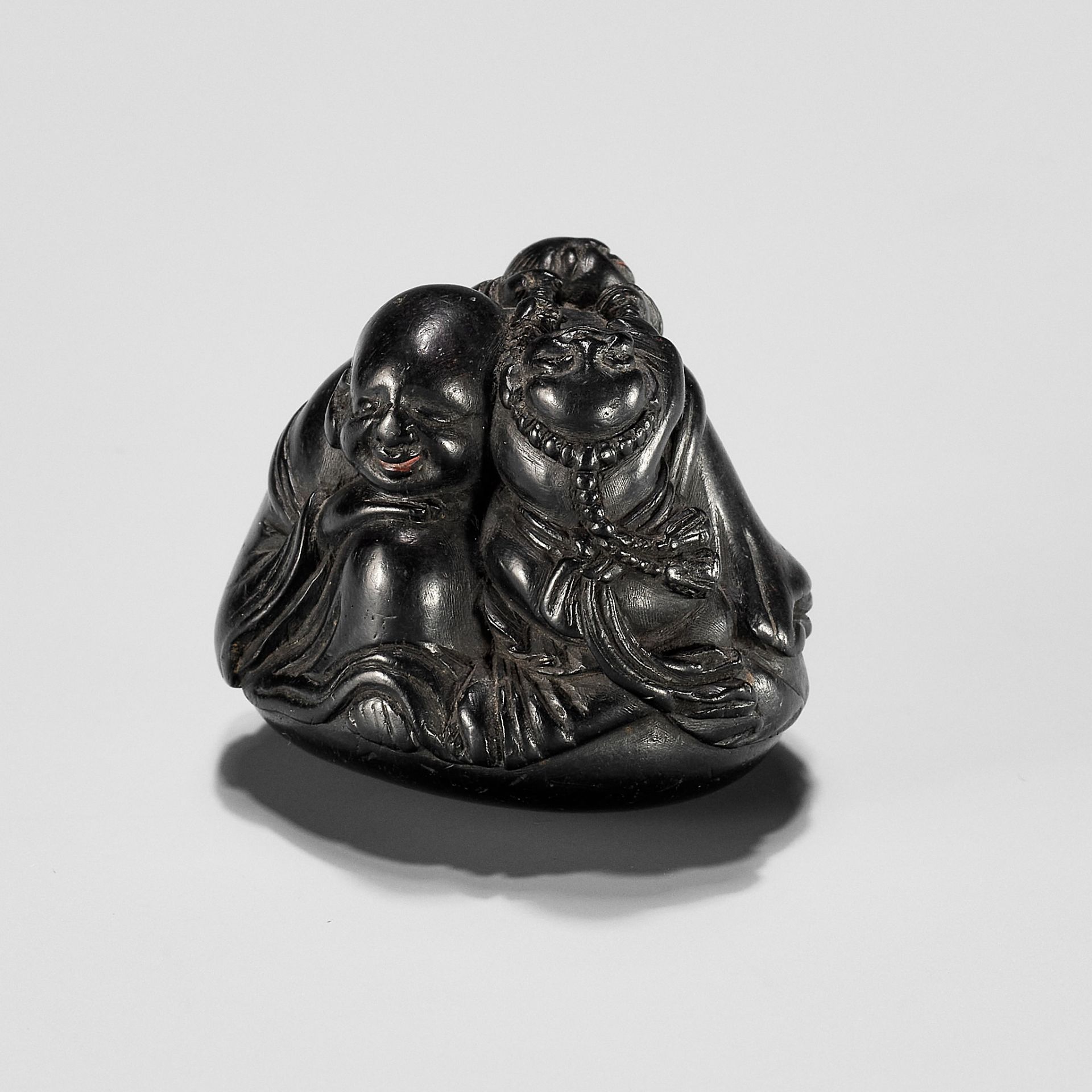 UNSHOKEN: A KUROGAKI NETSUKE DEPICTING HOTEI AND TWO BOYS