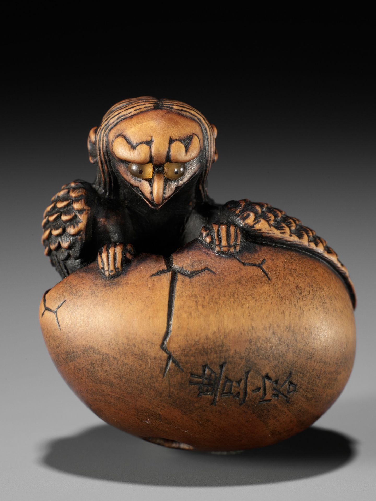 TOYOYO: A WOOD NETSUKE OF A HATCHING TENGU (TENGU NO TOMAGO)