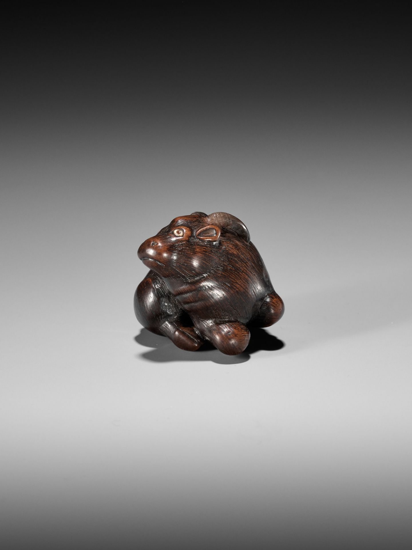 MASAKAZU: A FINE WOOD NETSUKE OF A RECUMBENT GOAT - Image 2 of 8