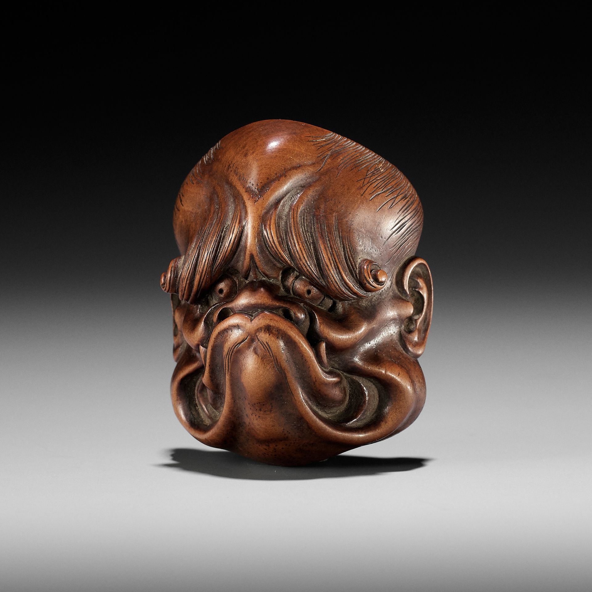 A FINE SANSHO-STYLE WOOD NETSUKE OF A GHOUL