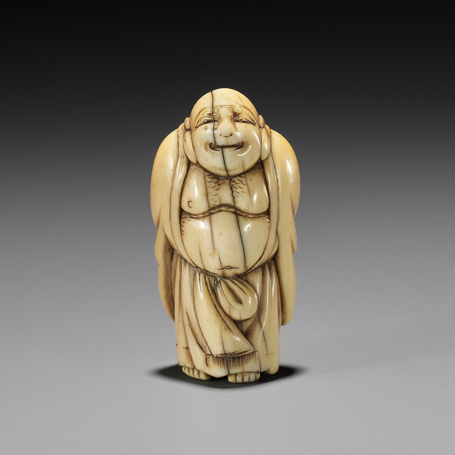 TOMO: AN EARLY OSAKA SCHOOL IVORY NETSUKE OF HOTEI