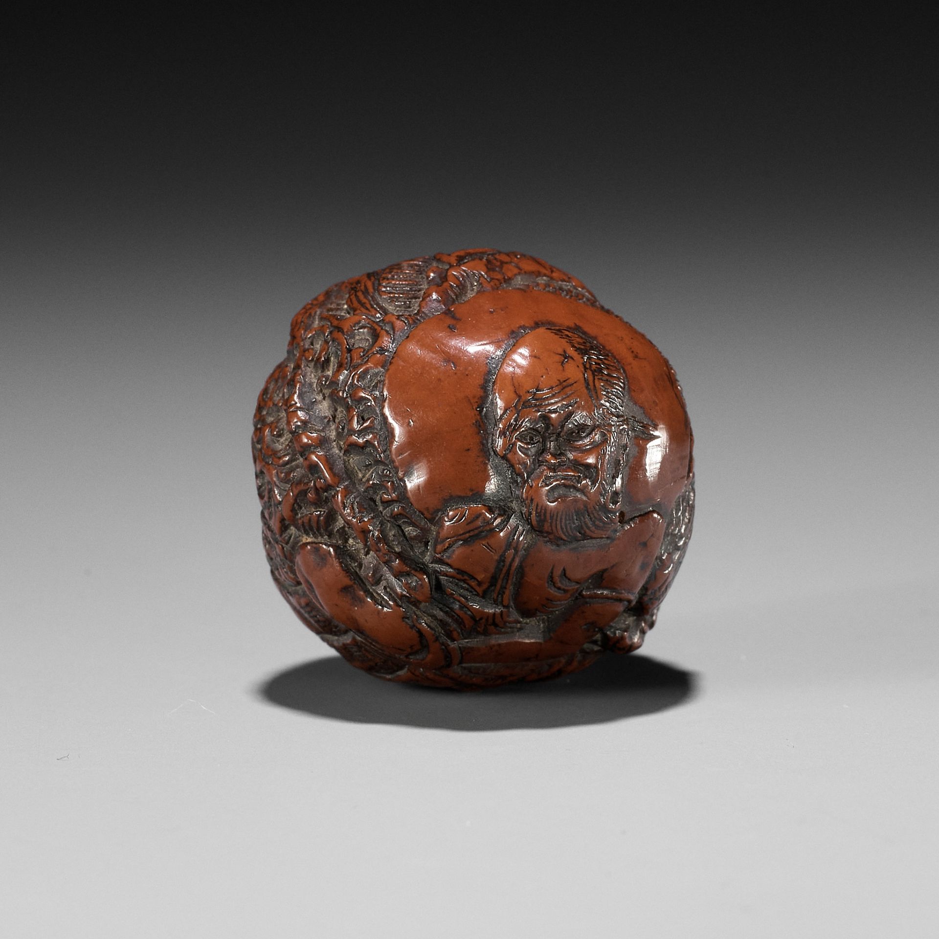 A KURUMI (WALNUT) NETSUKE OF RAKAN HANDAKA SONJA