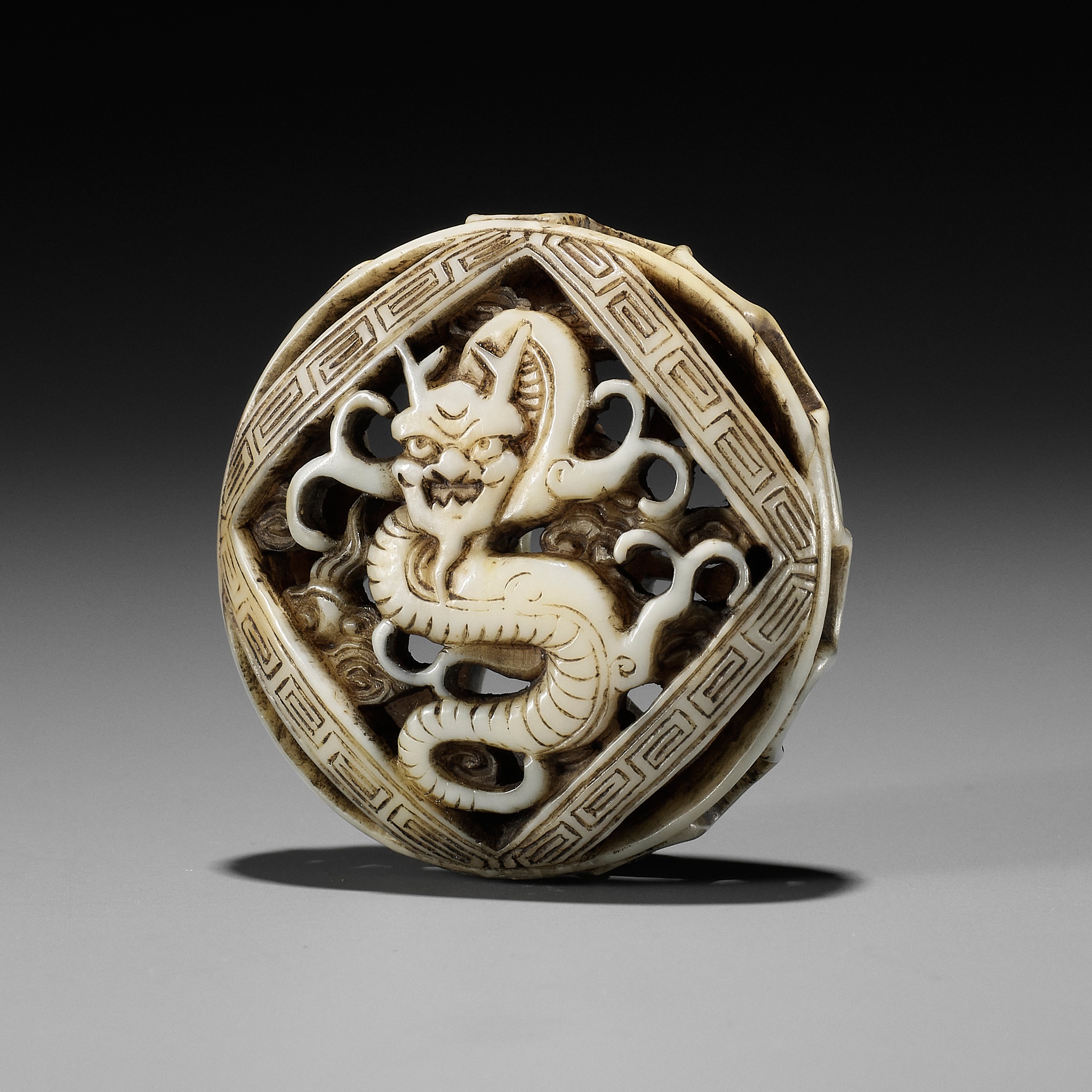 A FINE WALRUS IVORY RYUSA MANJU NETSUKE WITH DRAGON