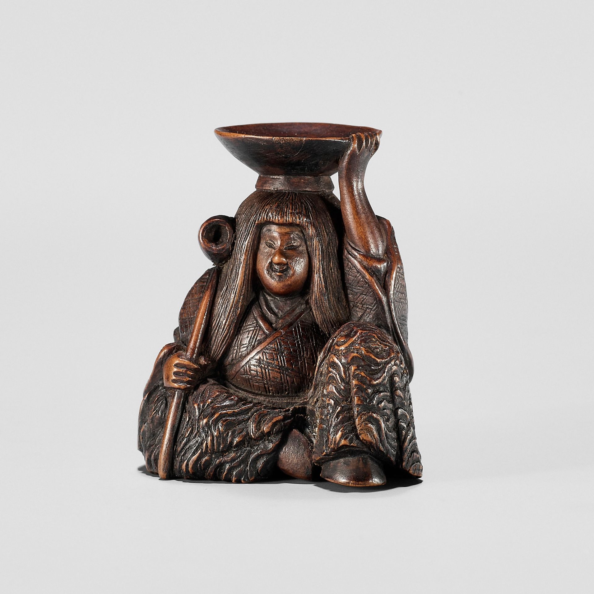 HIDEHARU: A NAGOYA SCHOOL WOOD NETSUKE OF A DRUNKEN SHOJO WITH LADLE AND SAKE SAUCER