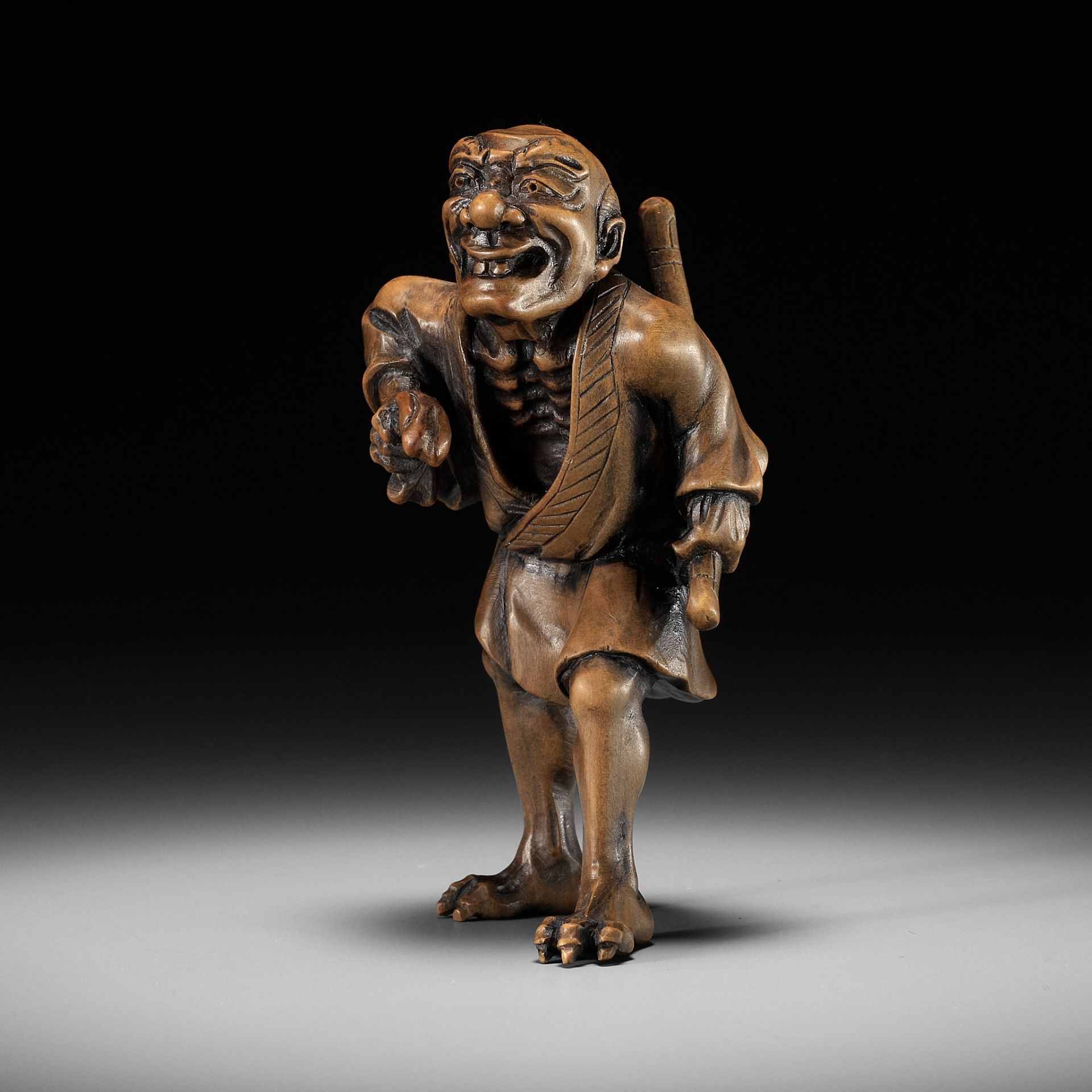 A HIGHLY UNUSUAL WOOD NETSUKE OF A SHAPESHIFTER