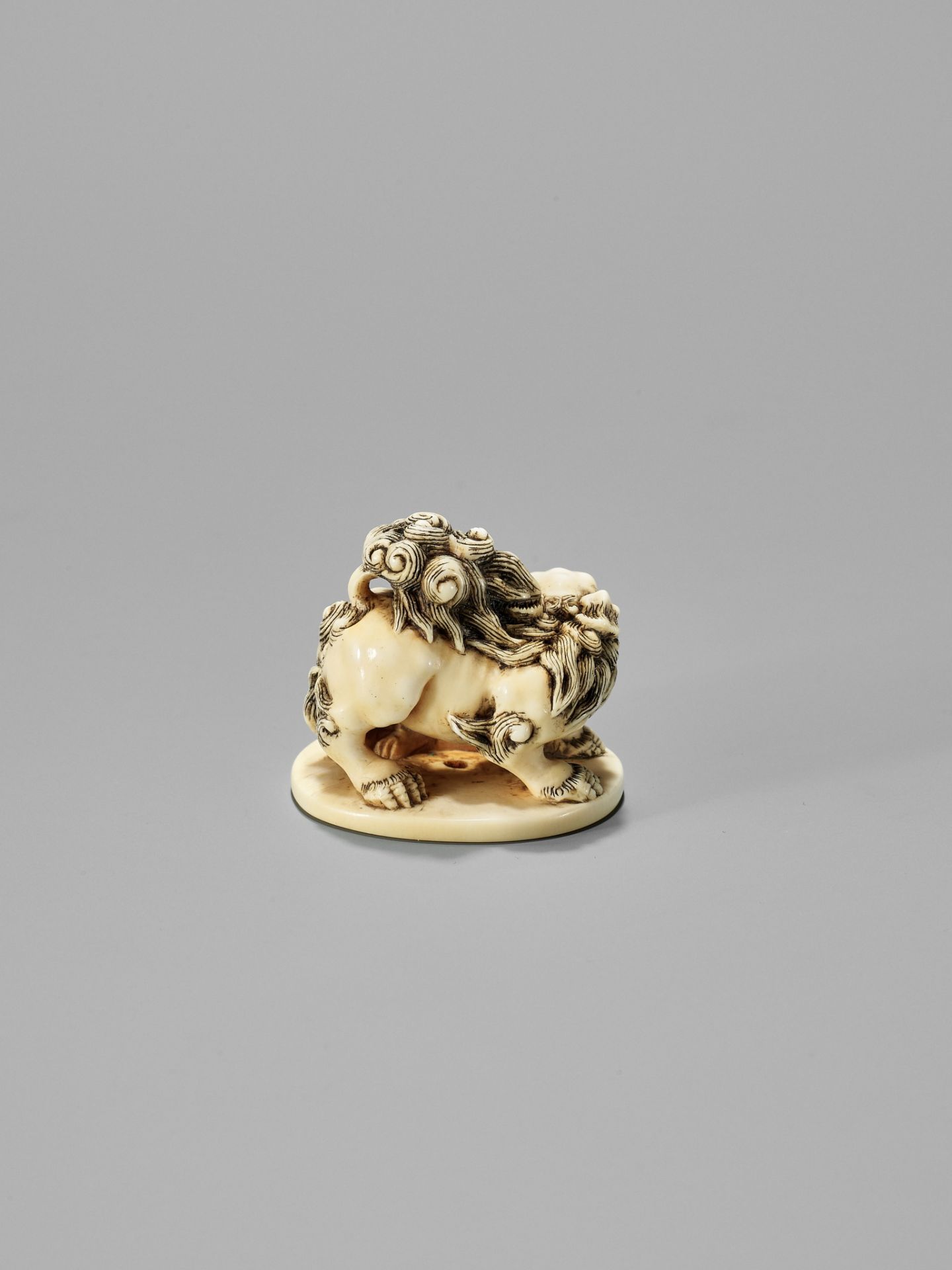 TOSHINAGA: AN IVORY NETSUKE OF A SHISHI WITH YOUNG - Image 2 of 12