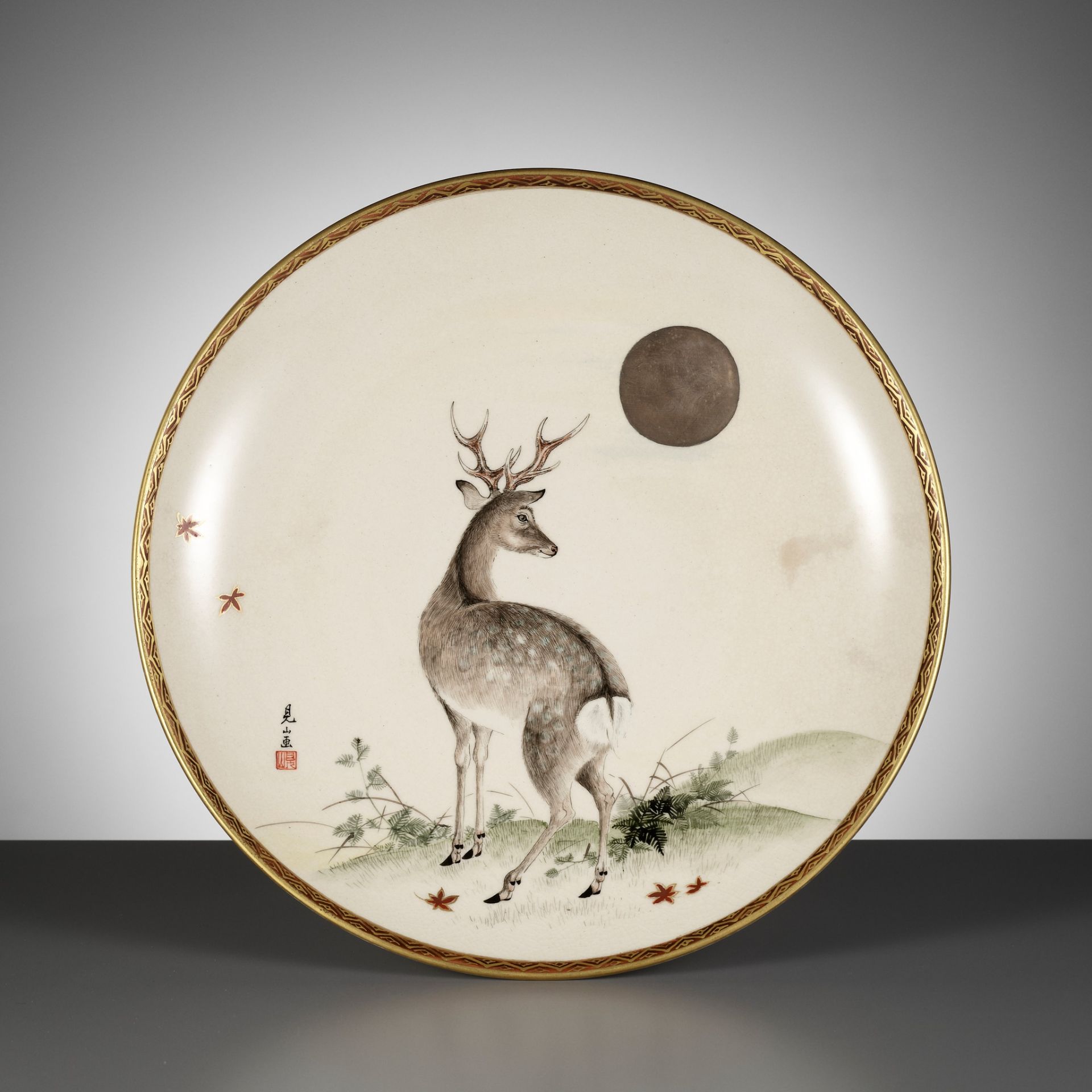 A FINE SATSUMA DISH WITH AN AUTUMNAL SCENE DEPICTING A DEER AND MOON, AFTER A DESIGN BY OGATA KENZAN