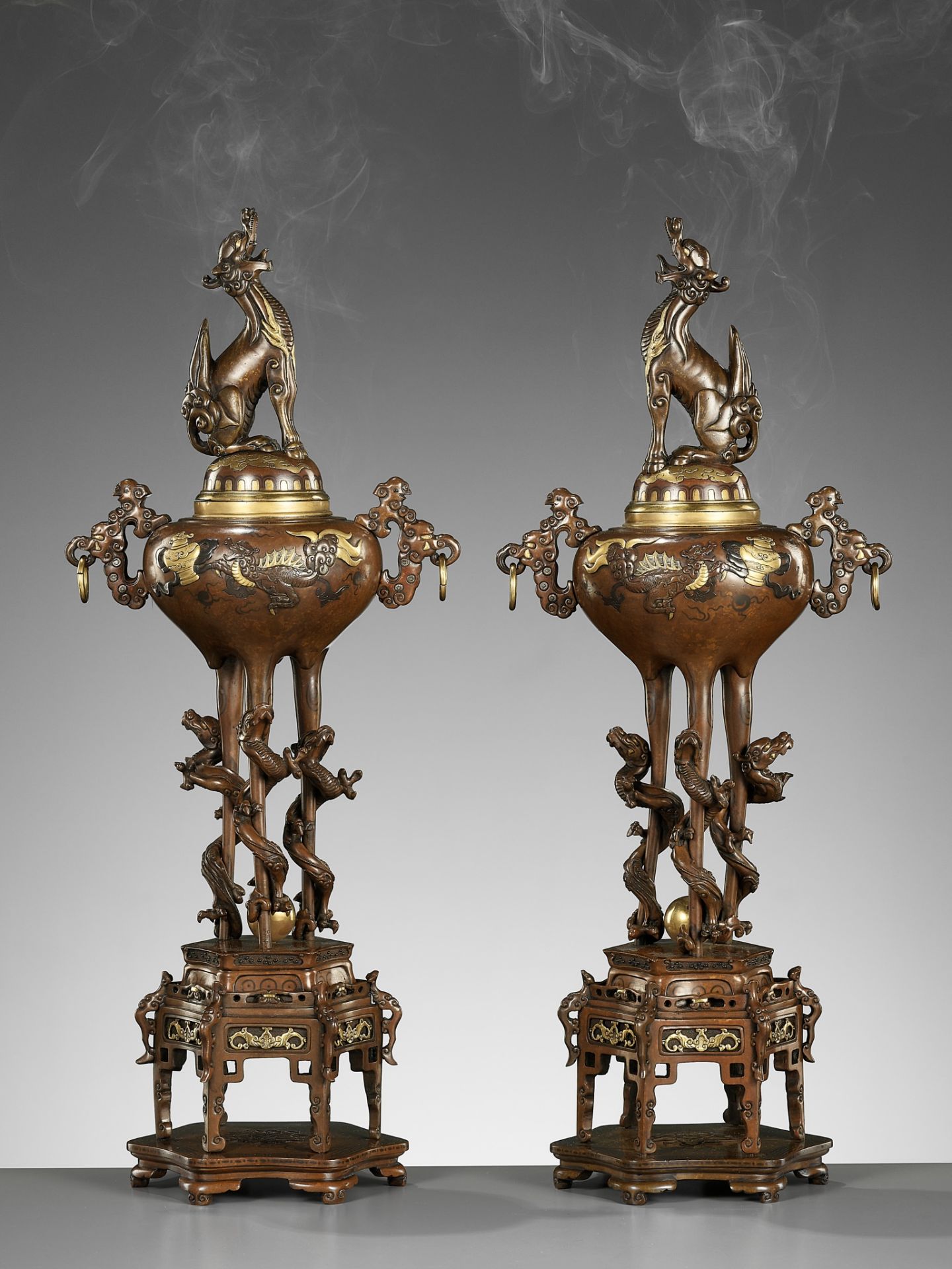 A PAIR OF SUPERB TAKAOKA GOLD-INLAID BRONZE 'MYTHICAL BEASTS' KORO (INCENSE BURNERS) AND COVERS