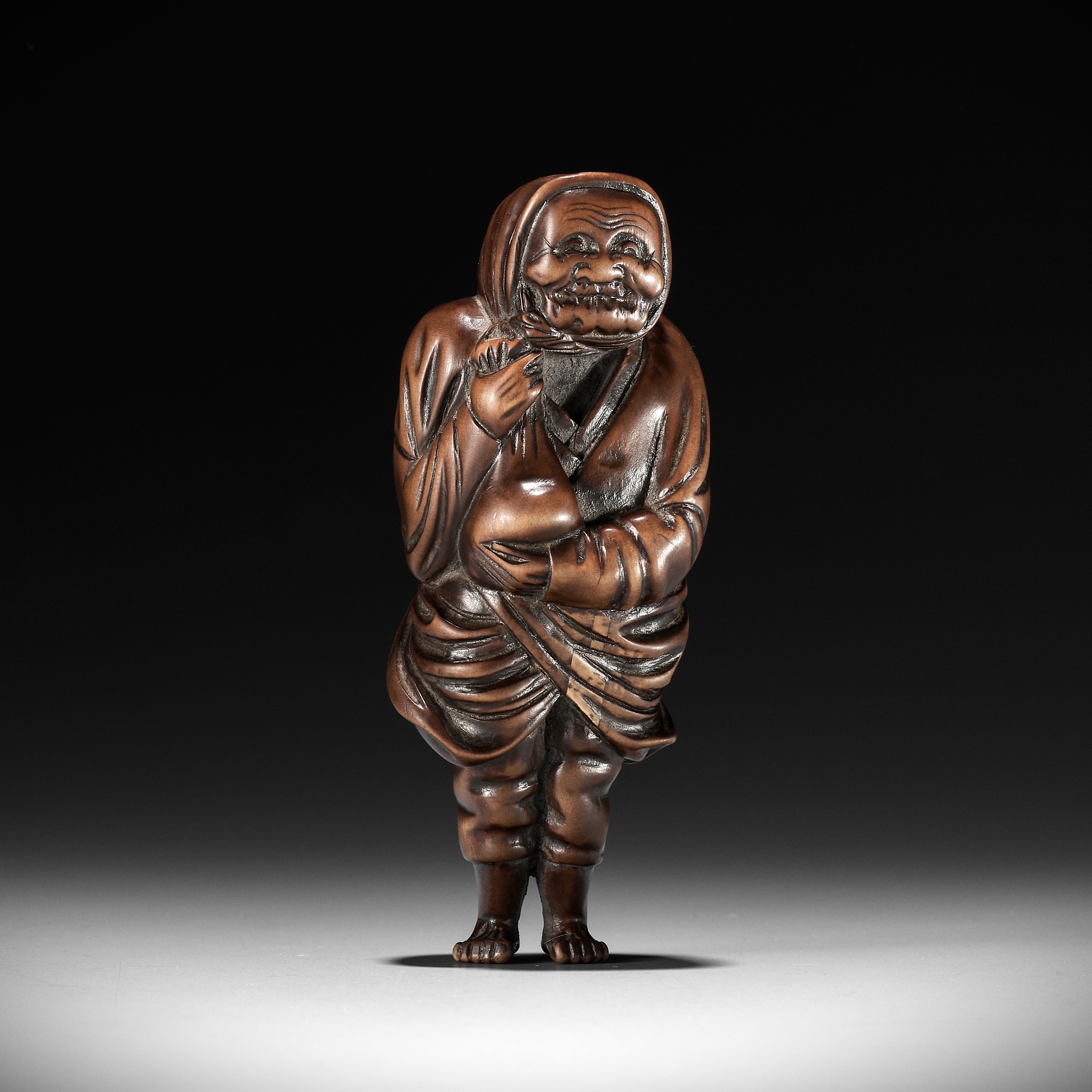 A SUPERB AND LARGE OSAKA SCHOOL WOOD NETSUKE OF A PEASANT