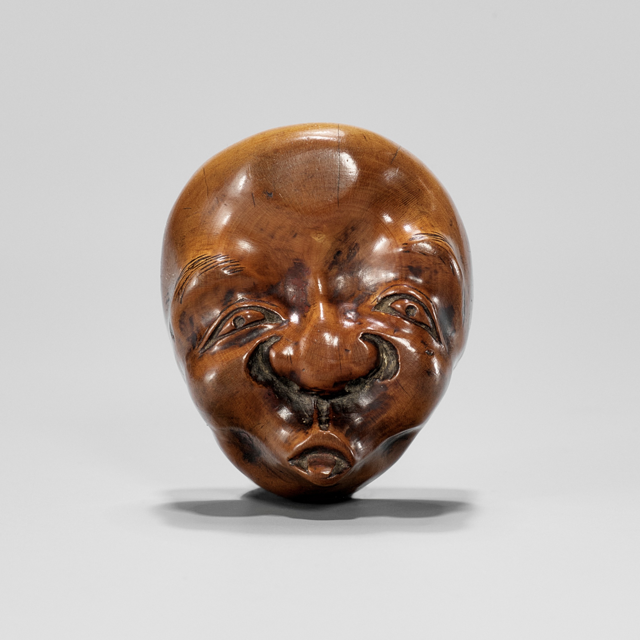 A RARE SHUNGA MASK NETSUKE OF HYOTTOKO