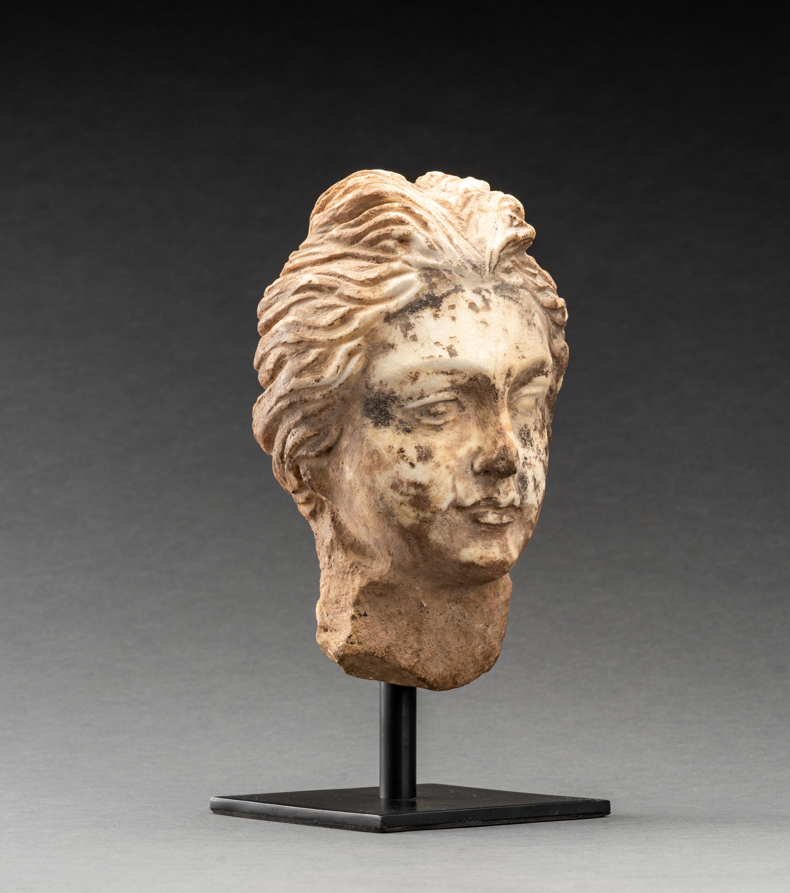 A GANDHARAN WHITE MARBLE HEAD OF A YOUNG MAN