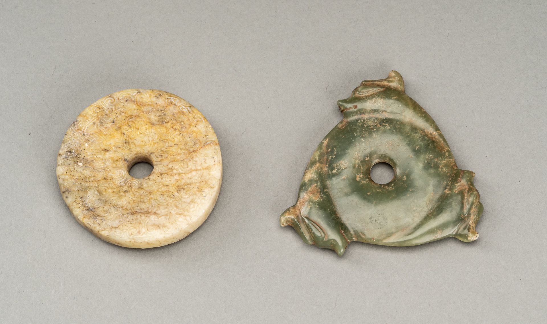 A LOT WITH TWO ARCHAISTIC HONGSHAN STYLE JADE DISCS, QING