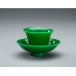 AN APPLE GREEN GLASS CUP AND SAUCER