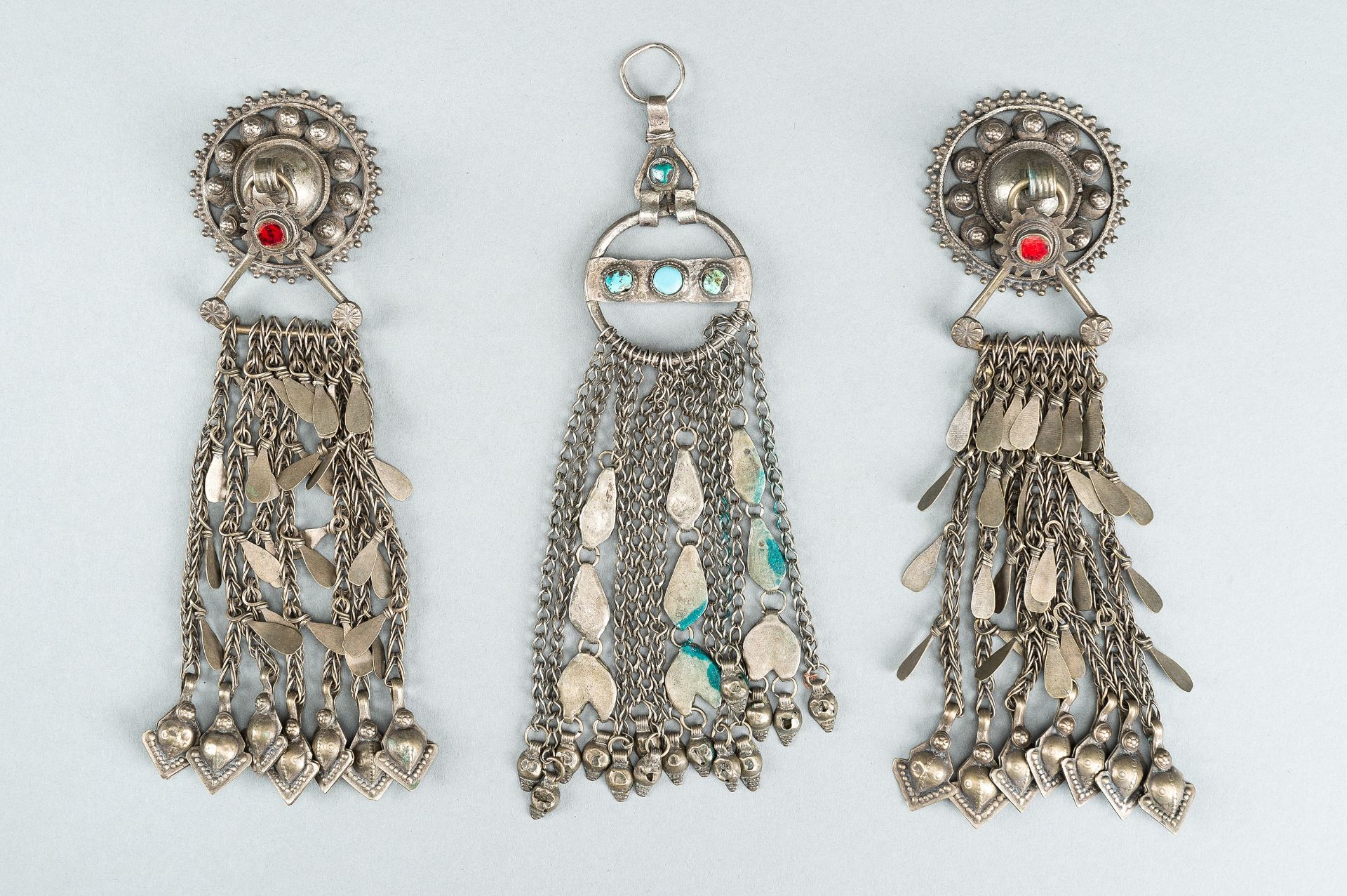 THREE TRIBAL AFGHAN METAL ORNAMENTS WITH INSETS, c. 1950s