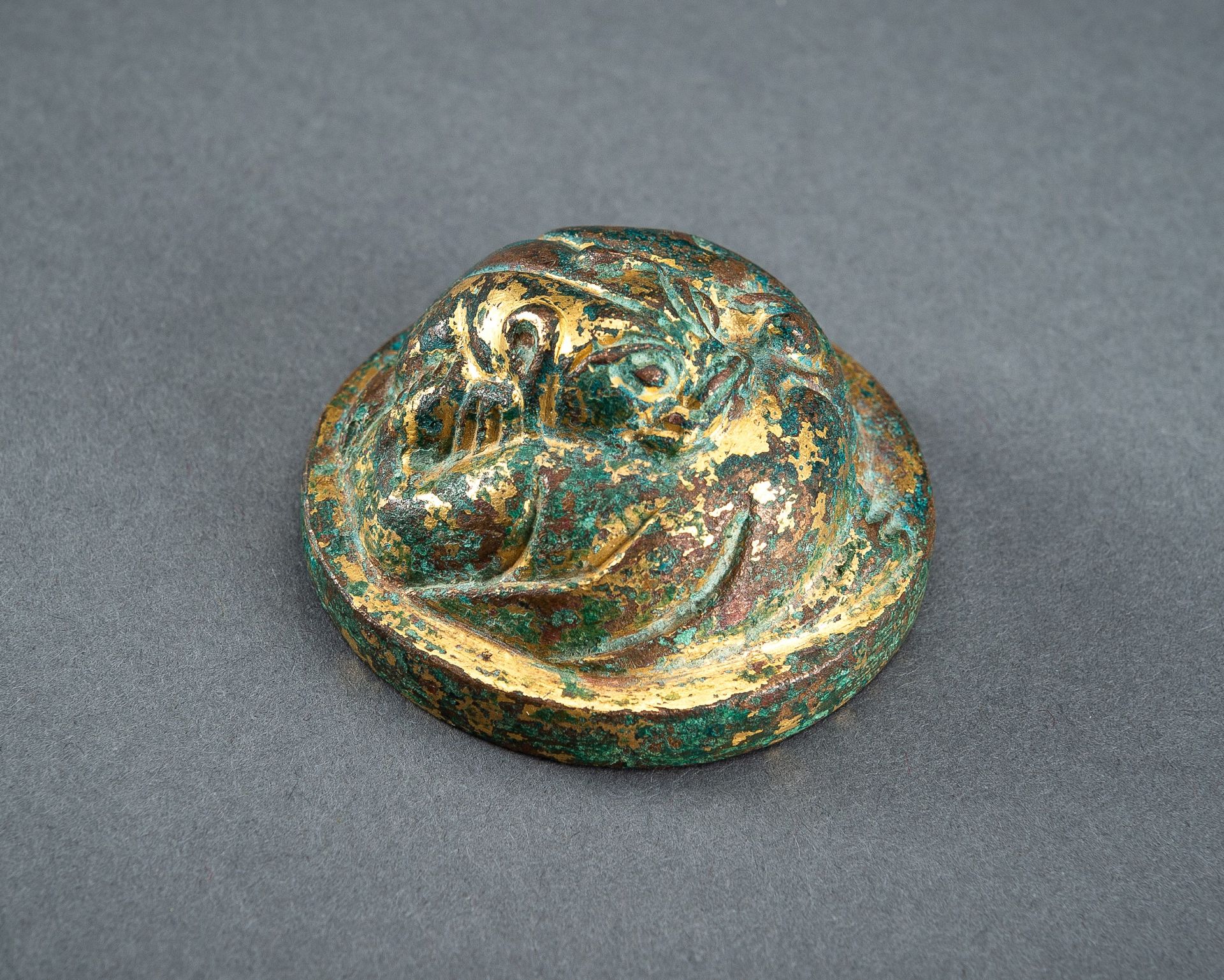 A GILT-BRONZE HAN DYNASTY 'LION' SCROLL WEIGHT