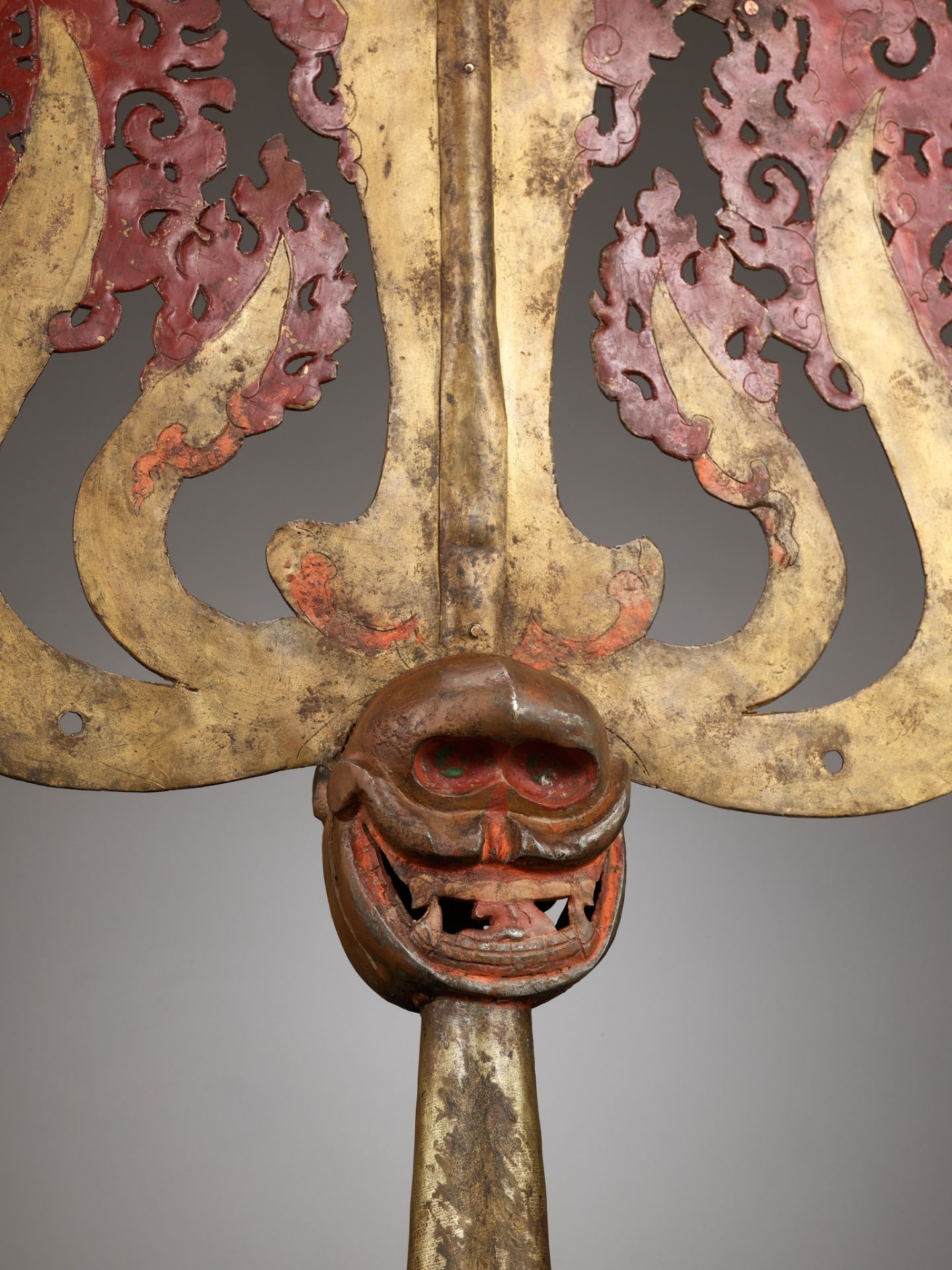 A LARGE LACQUERED AND GILT COPPER-ALLOY TRISHULA FITTING, TIBET, 17TH - 18TH CENTURY