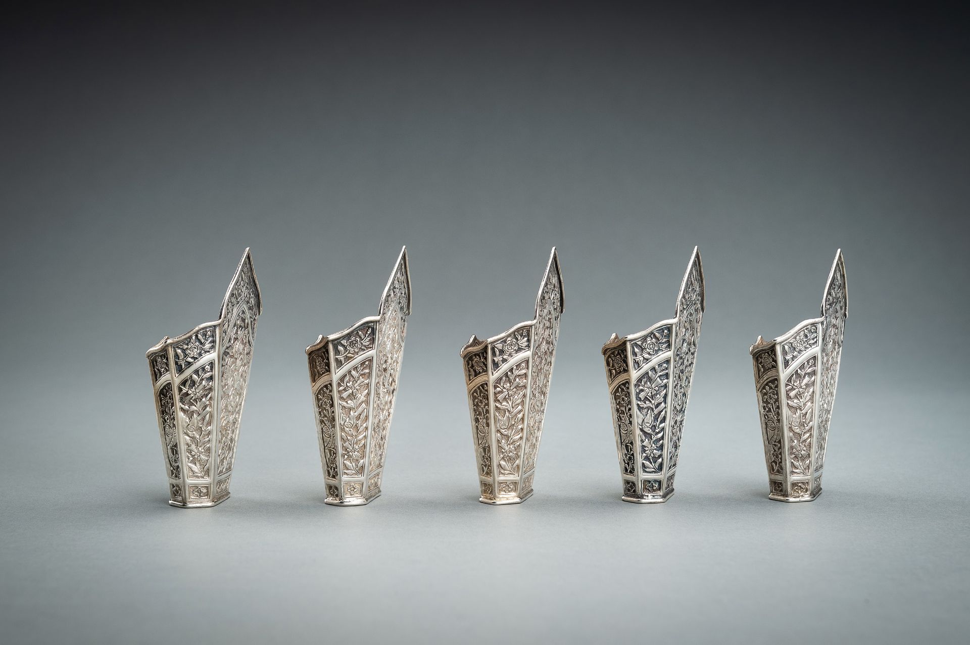 A GROUP OF FIVE EMBOSSED SILVER BETEL LEAF HOLDERS, c. 1900s - Image 5 of 19