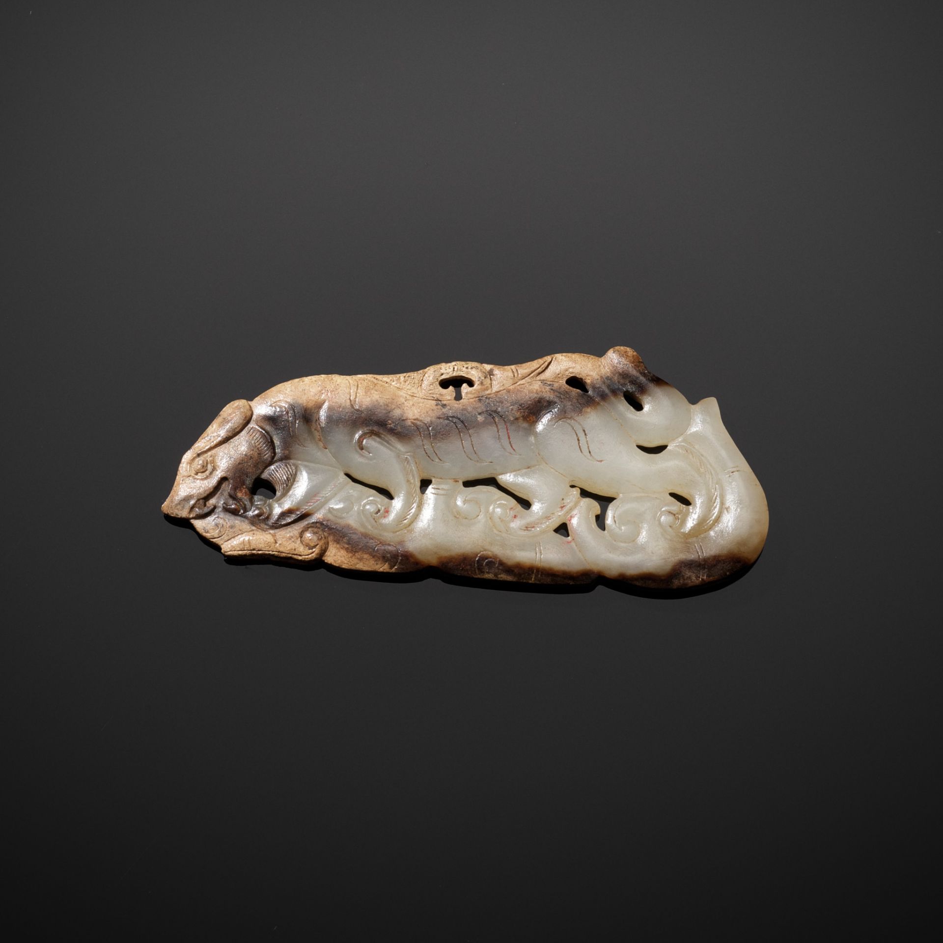 AN EXTRAORDINARY WHITE JADE 'TIGER' PENDANT, EASTERN ZHOU - HAN