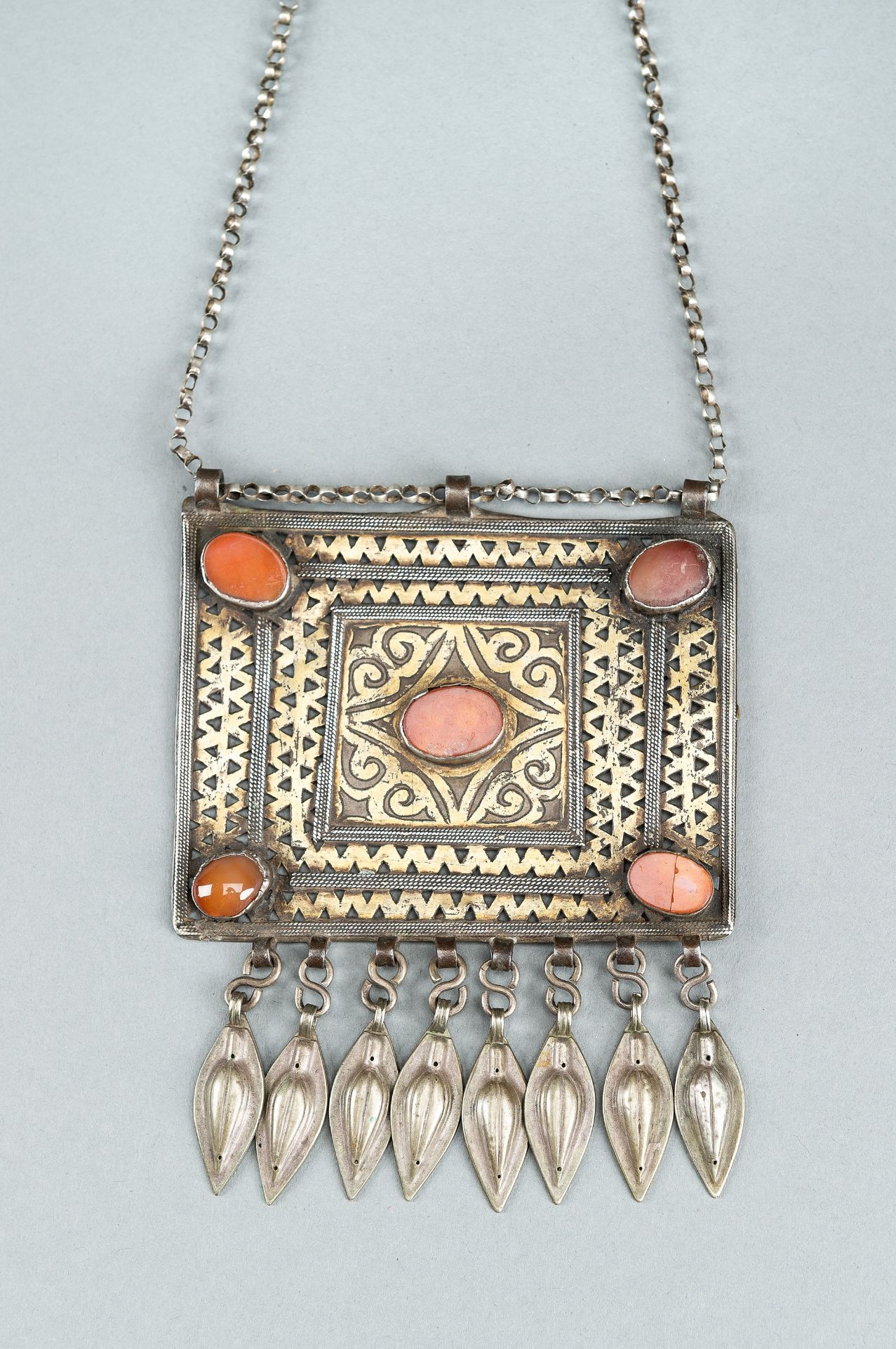 A TURKOMAN METAL AND CARNELIAN CHEST ORNAMENT, c. 1900s