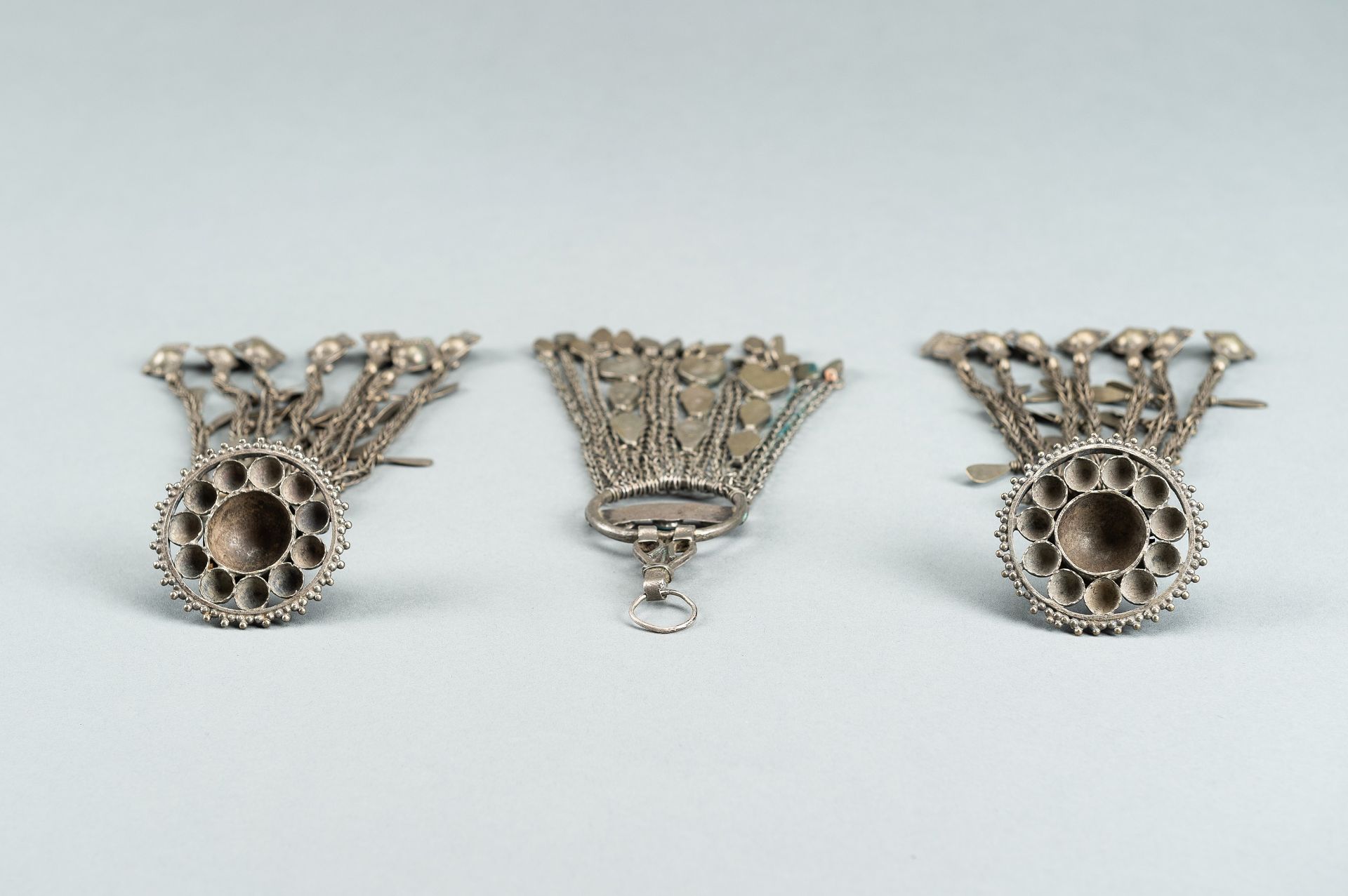 THREE TRIBAL AFGHAN METAL ORNAMENTS WITH INSETS, c. 1950s - Image 16 of 16