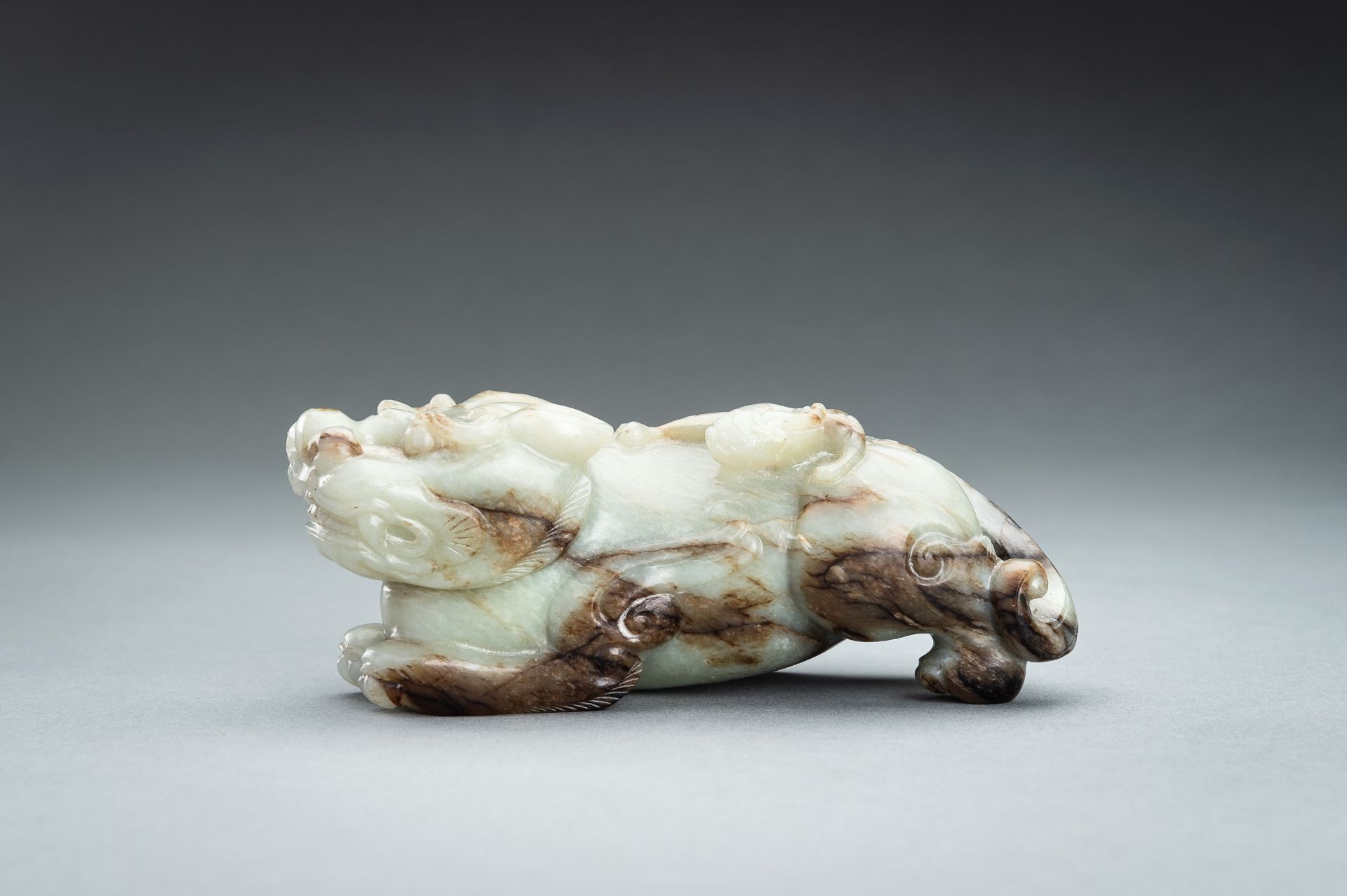 A CELADON AND RUSSET JADE `BIXIEÂ´, QING - Image 3 of 12