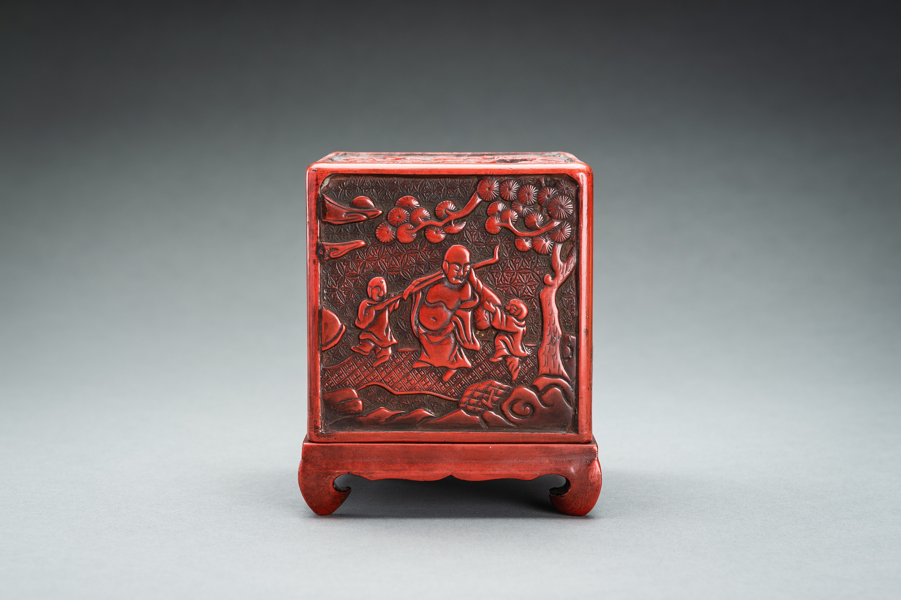 A CINNABAR LACQUER 'IMMORTALS AND BUDAI' BOX AND COVER, QING - Image 9 of 14