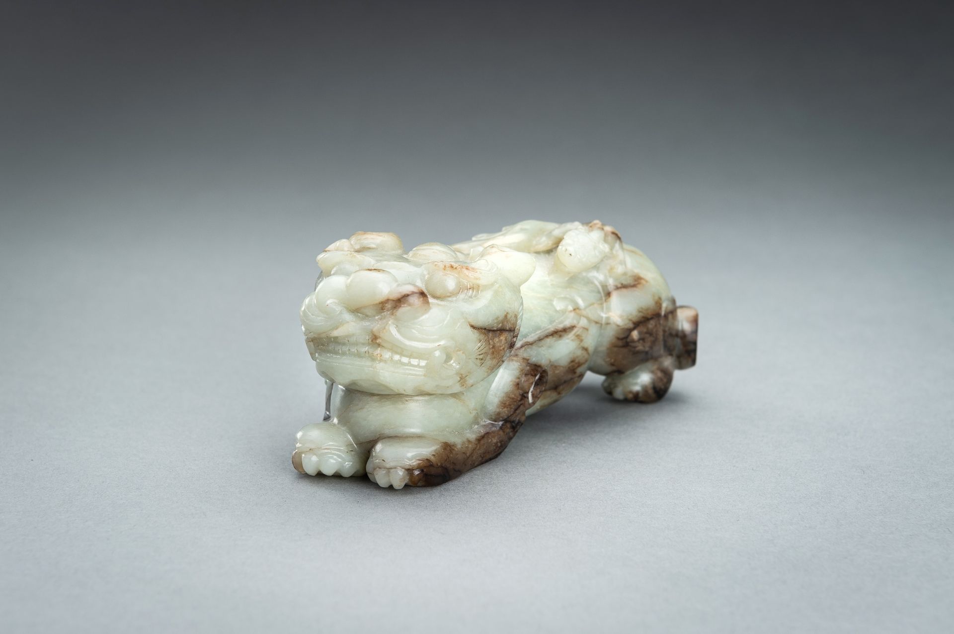 A CELADON AND RUSSET JADE `BIXIEÂ´, QING - Image 9 of 12