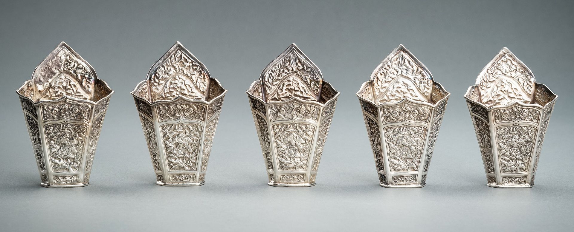 A GROUP OF FIVE EMBOSSED SILVER BETEL LEAF HOLDERS, c. 1900s