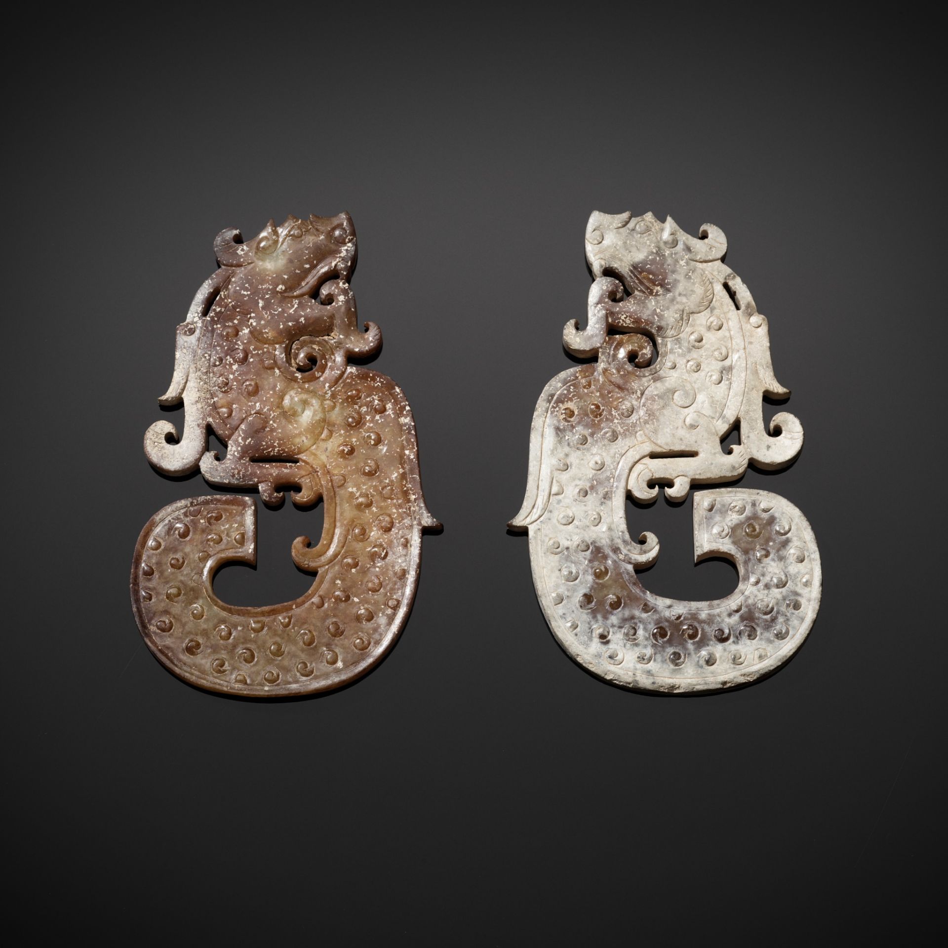 A PAIR OF JADE 'DRAGON' PENDANTS