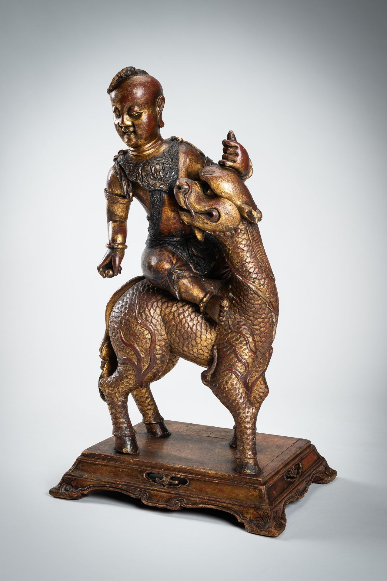 A VERY LARGE GILT-LACQUERED WOOD STATUE OF YOUNG BUDDHA RIDING QILIN - Image 3 of 19