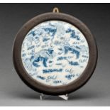 A BLUE AND WHITE PORCELAIN WALL PLAQUE WITH BUDDHIST LIONS