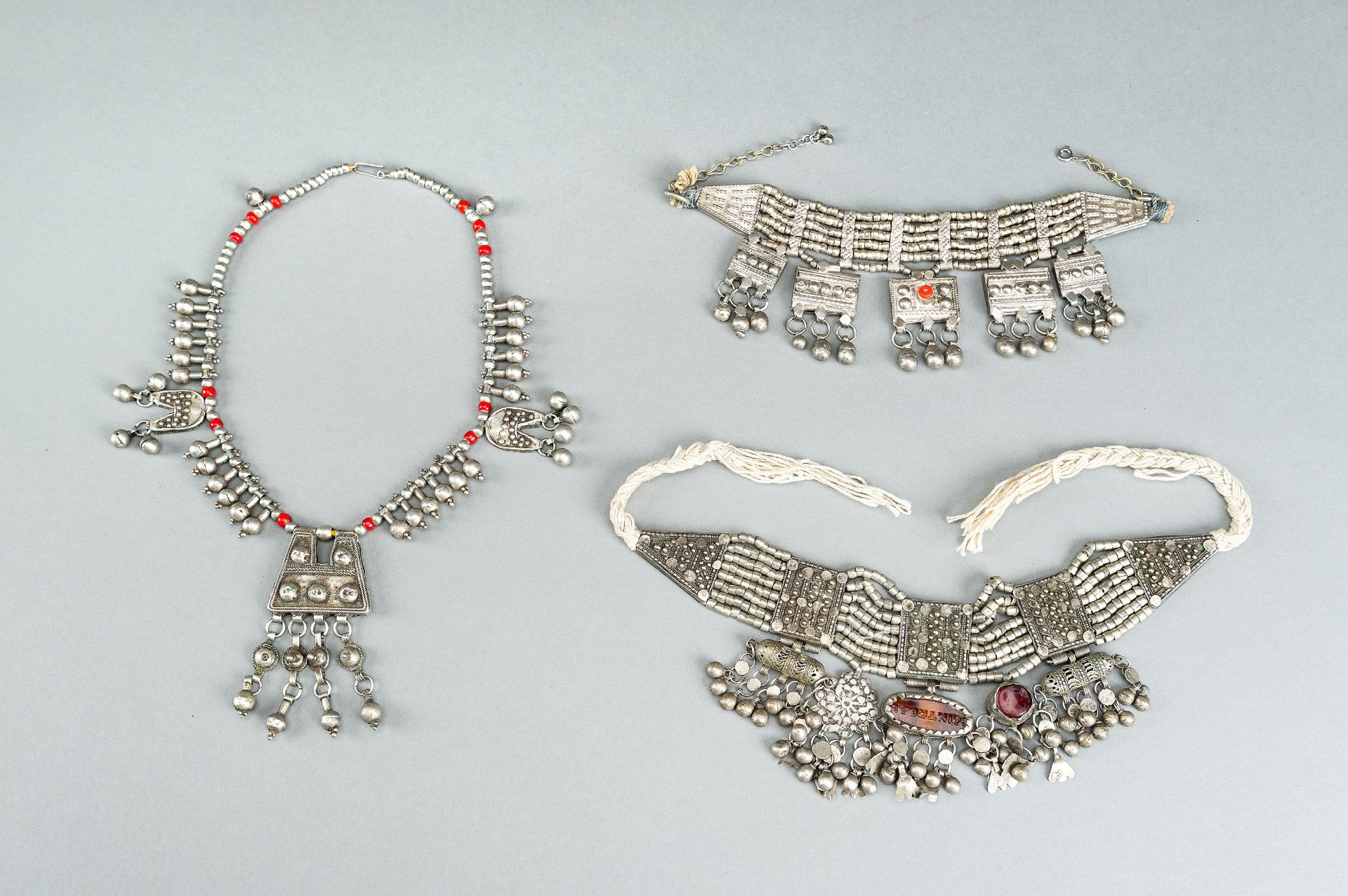 A GROUP OF THREE WHITE METAL LAZEM AMULET NECKLACES, c 1930s