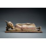 A LACQUERED POTTERY FIGURE OF THE RECLINING BUDDHA, 17th - 18th CENTURY