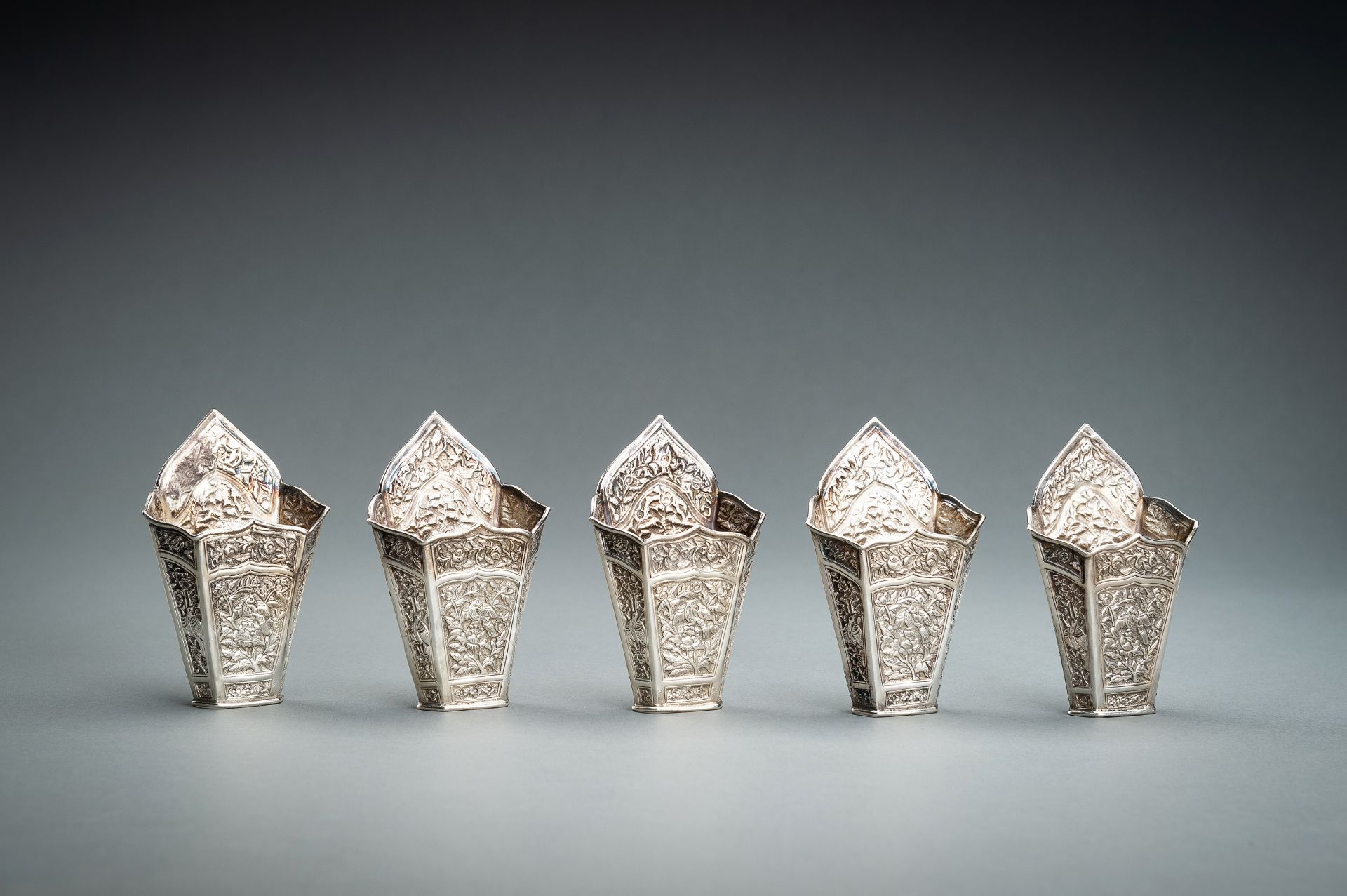 A GROUP OF FIVE EMBOSSED SILVER BETEL LEAF HOLDERS, c. 1900s - Image 2 of 19