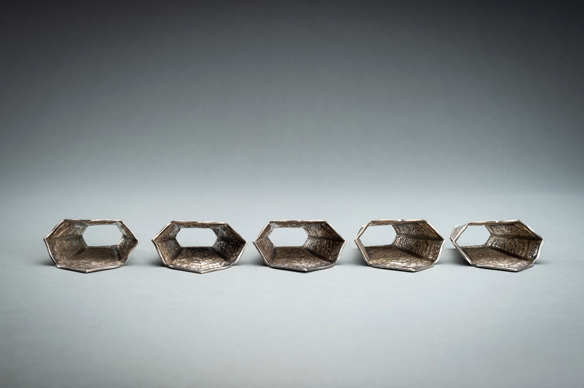 A GROUP OF FIVE EMBOSSED SILVER BETEL LEAF HOLDERS, c. 1900s - Image 8 of 19