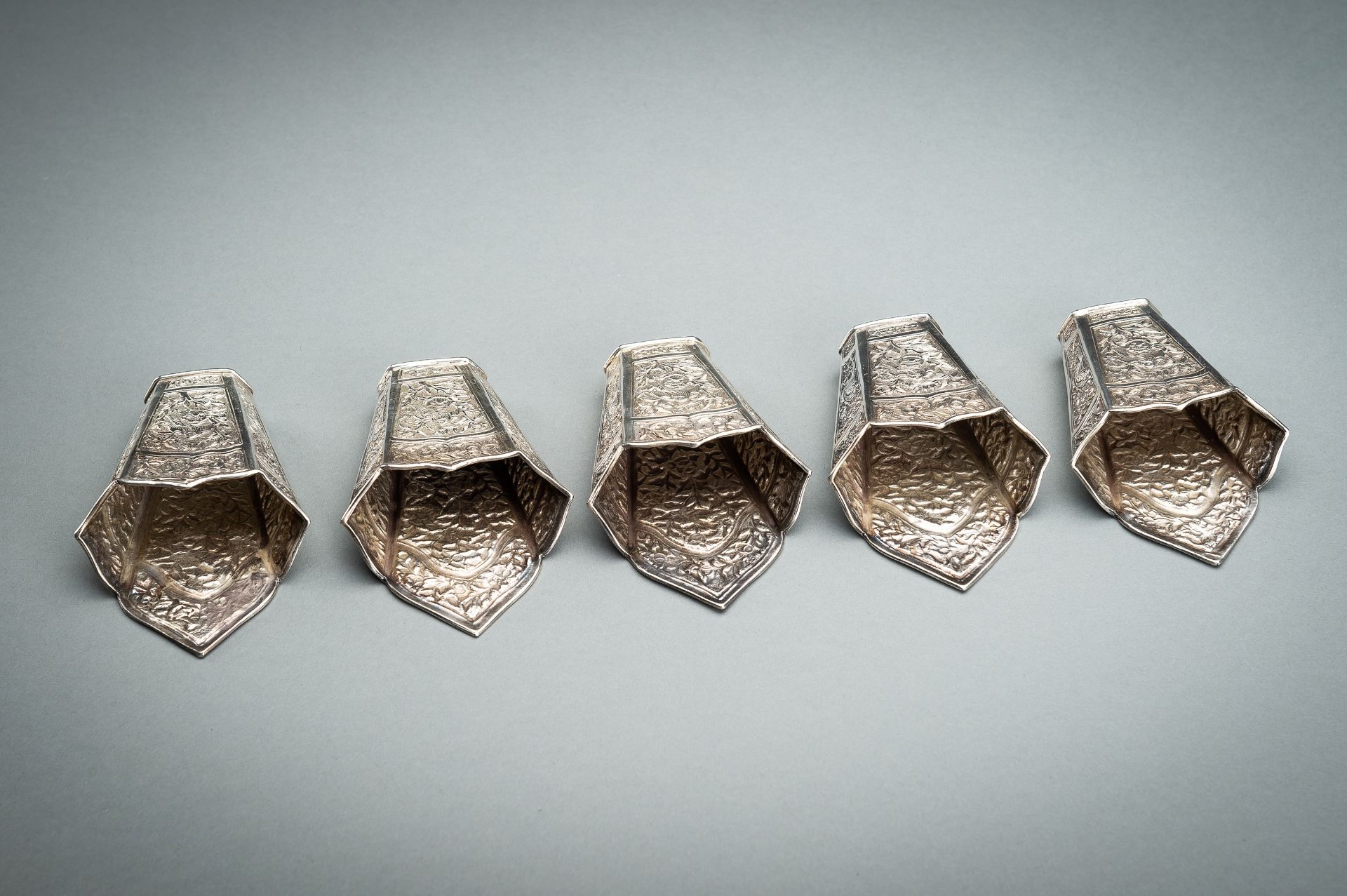 A GROUP OF FIVE EMBOSSED SILVER BETEL LEAF HOLDERS, c. 1900s - Image 3 of 19