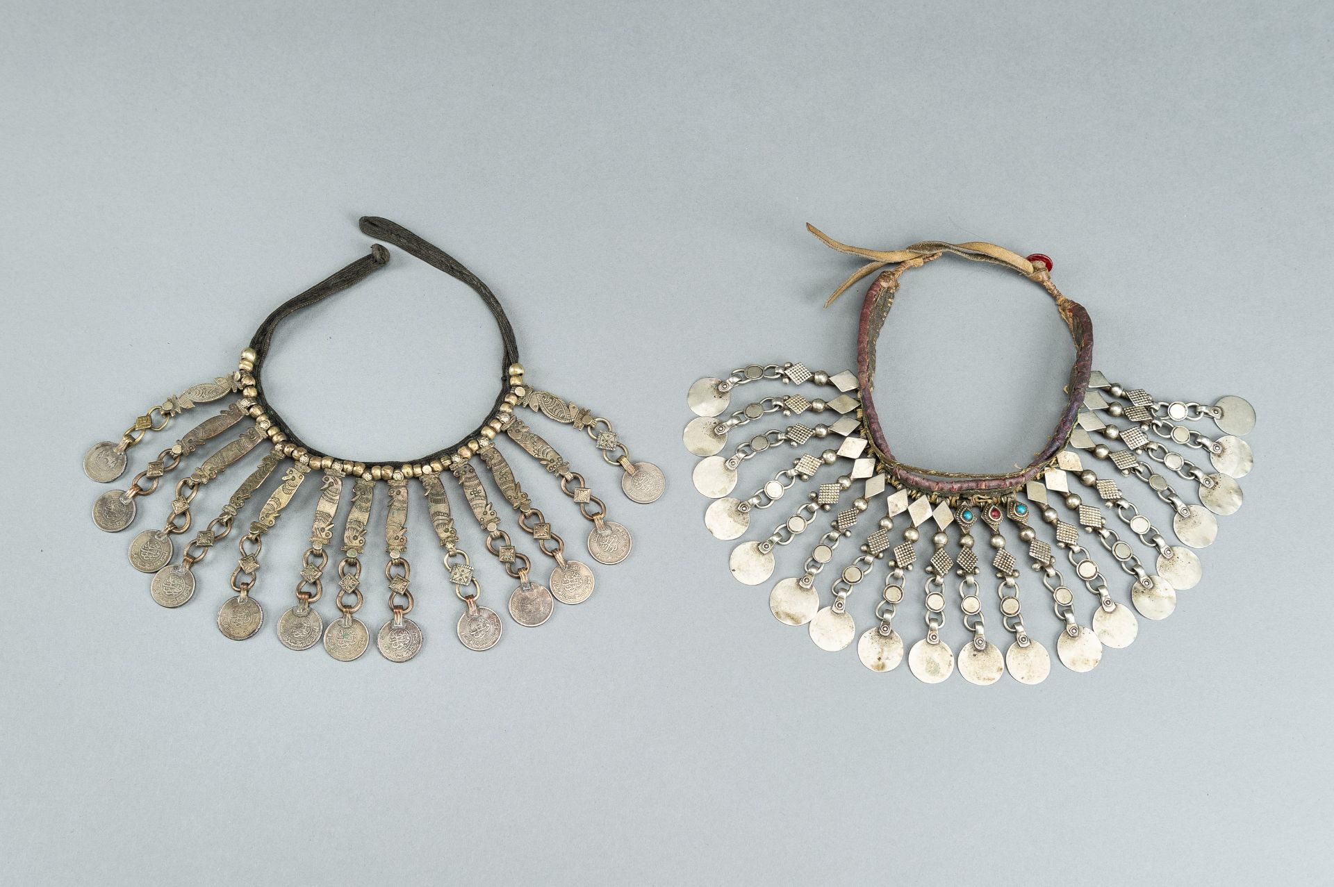 TWO TRIBAL SILVER AND METAL NECKLACES, ONE WITH AFGHAN COINS, c.1950s