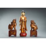 A VIETNAMESE GILT-LACQUERED WOOD FIGURE OF BUDDHA AND A PAIR OF BUDDHIST LIONS