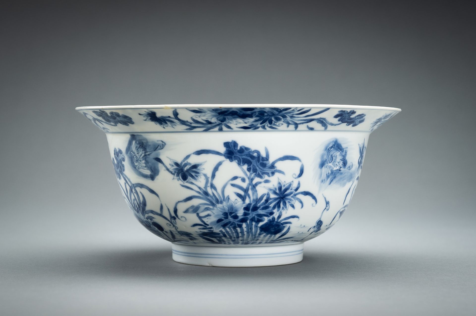 A BLUE AND WHITE PORCELAIN 'FLOWERS AND CRANES' BOWL, KANGXI