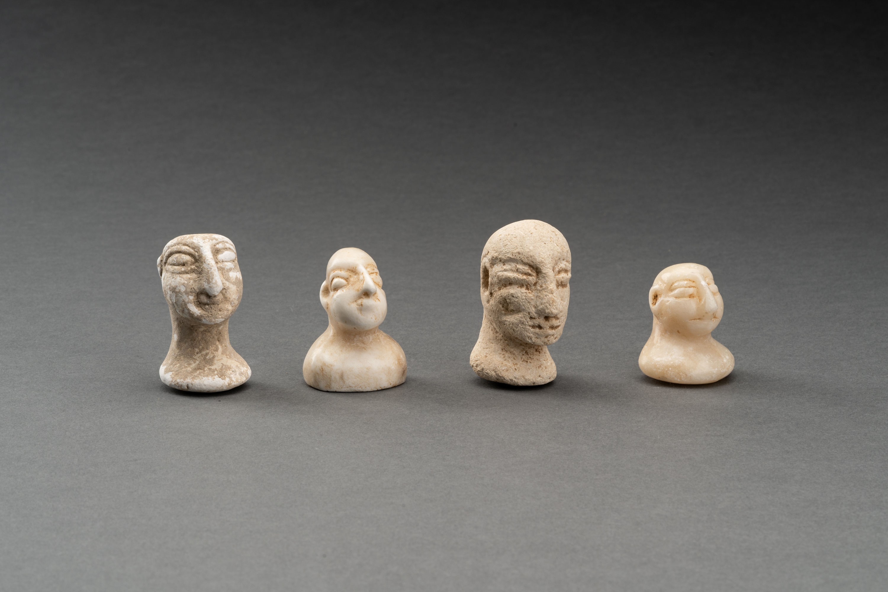 A LOT WITH FOUR BACTRIAN WHITE MARBLE AND STONE IDOL HEADS - Image 2 of 7