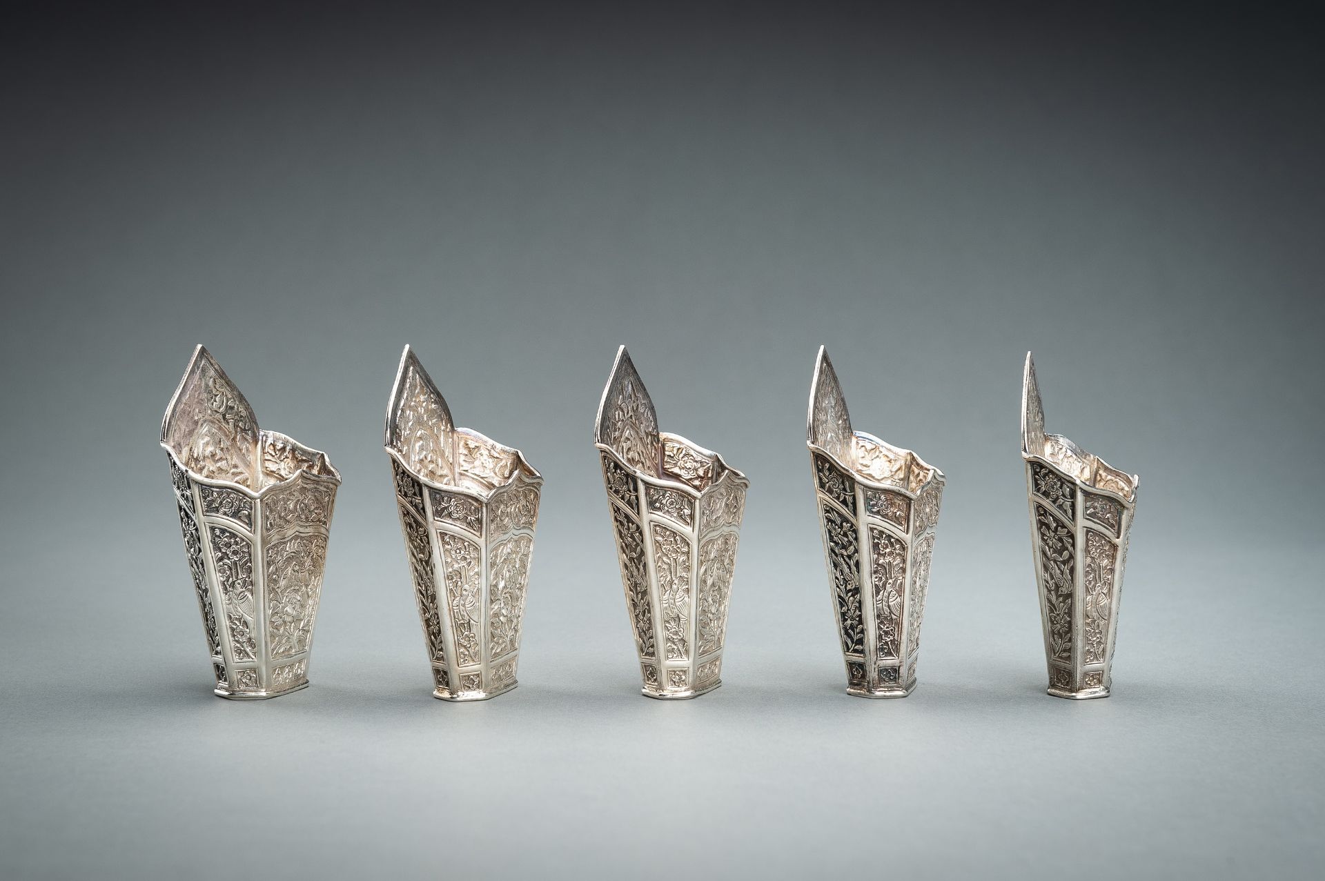 A GROUP OF FIVE EMBOSSED SILVER BETEL LEAF HOLDERS, c. 1900s - Image 6 of 19