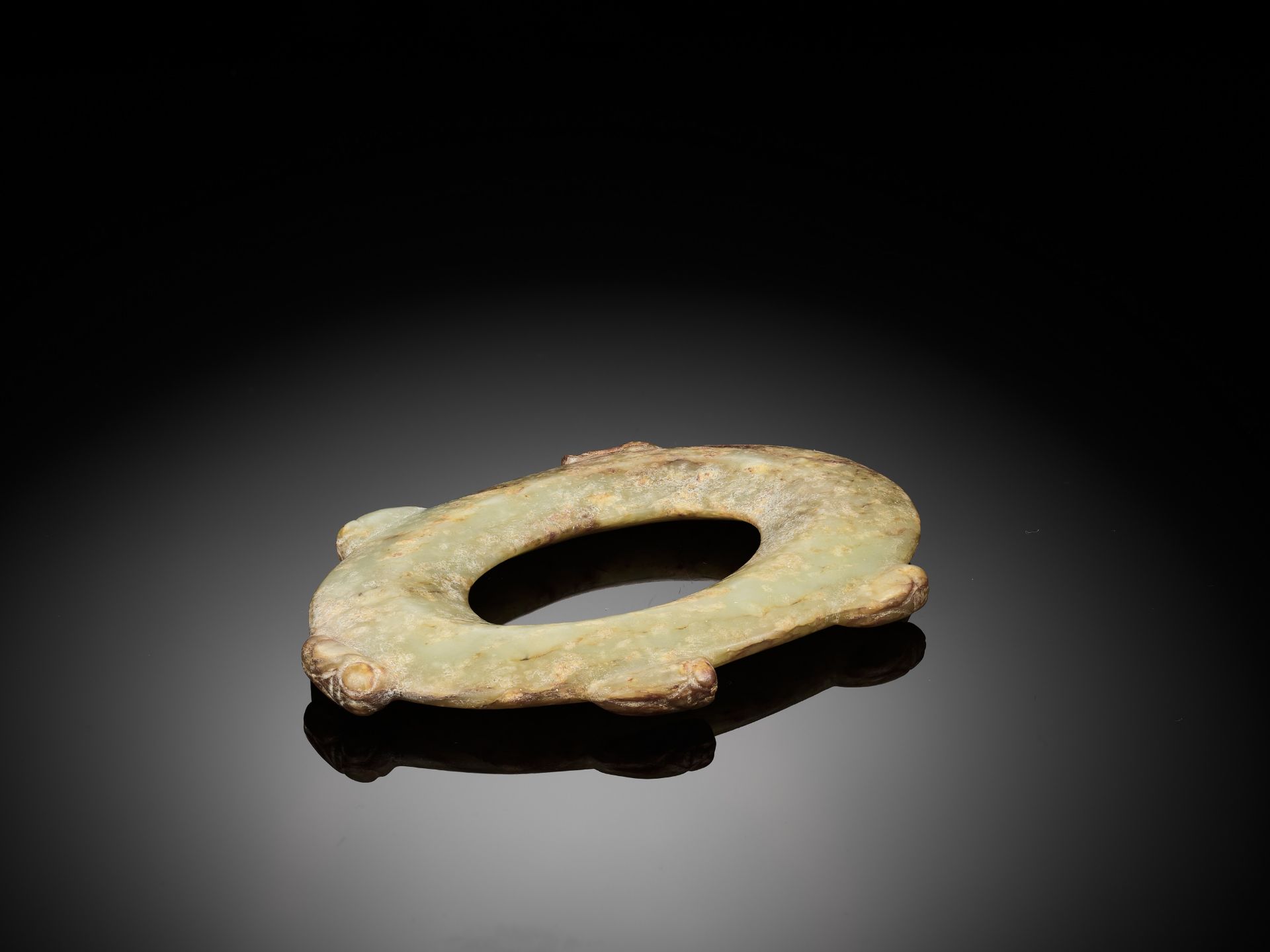 AN ARCHAISTIC CELADON AND RUSSET OVAL JADE DISC - Image 5 of 5
