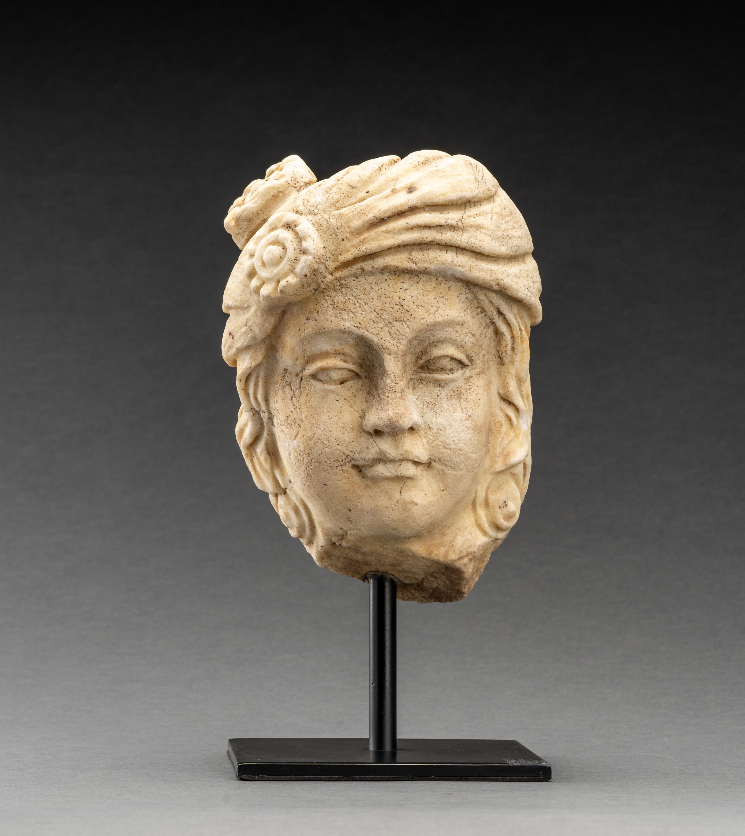 A GANDHARAN WHITE MARBLE HEAD OF A NOBLE LADY