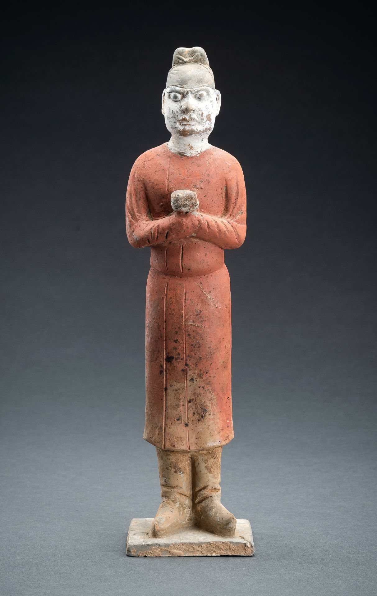 A RARE POTTERY FIGURE OF A COURT SERVANT, TANG DYNASTY