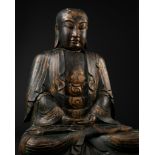 A MONUMENTAL GILT-LACQUERED PAUWLOWNIA WOOD TEMPLE STATUE OF A LUOHAN, QING DYNASTY OR EARLIER