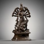 A SMALL BRONZE FIGURE OF DURGA SLAYING THE BUFFALO-DEMON MAHISHA, INDIA, 16TH-17TH CENTURY