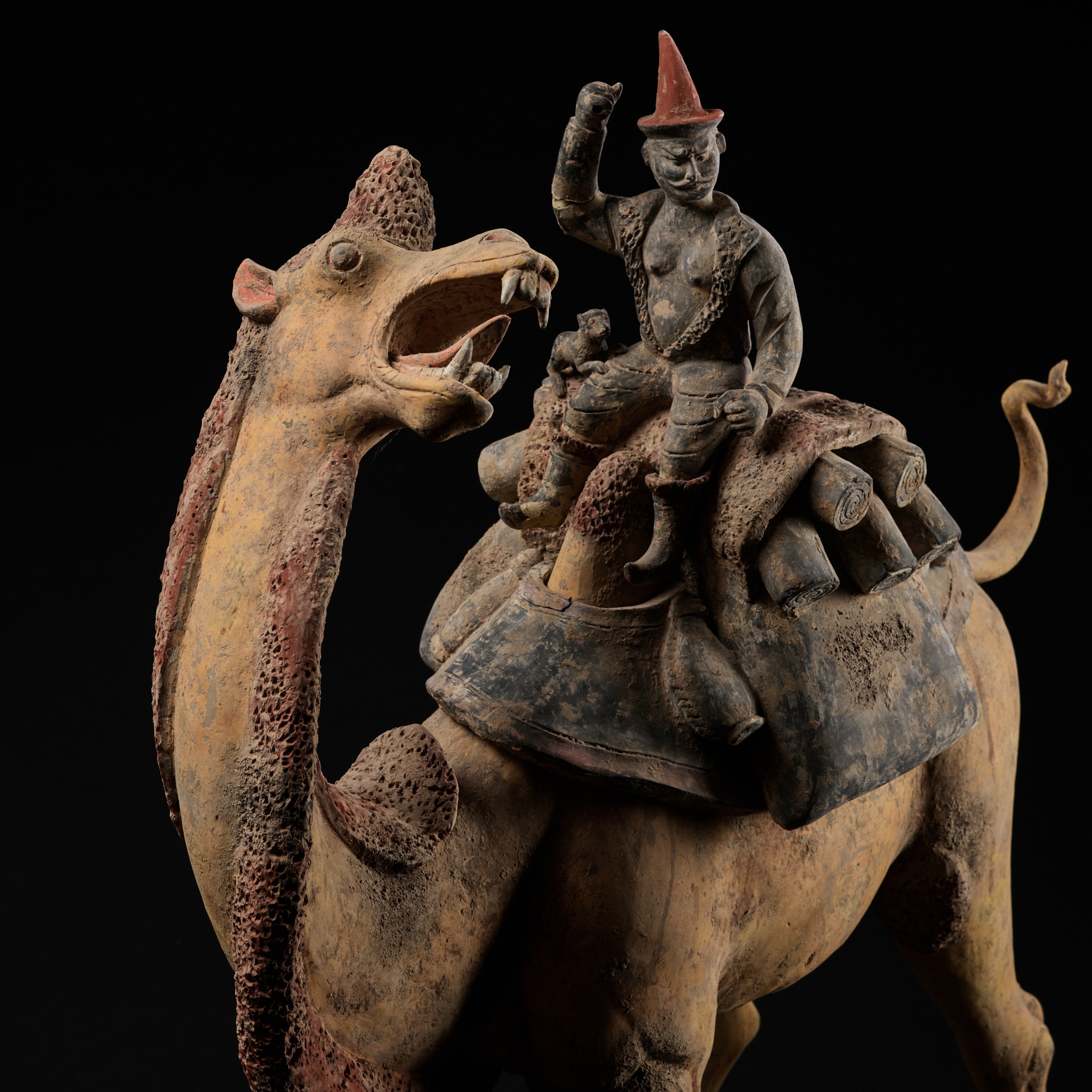 AN EXCEPTIONALLY LARGE PAINTED POTTERY FIGURE OF A BACTRIAN CAMEL AND A SOGDIAN RIDER, TANG DYNASTY
