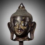 A MONUMENTAL GILT DRY LACQUER HEAD OF BUDDHA, AVA STYLE, BURMA, 17TH-18TH CENTURY