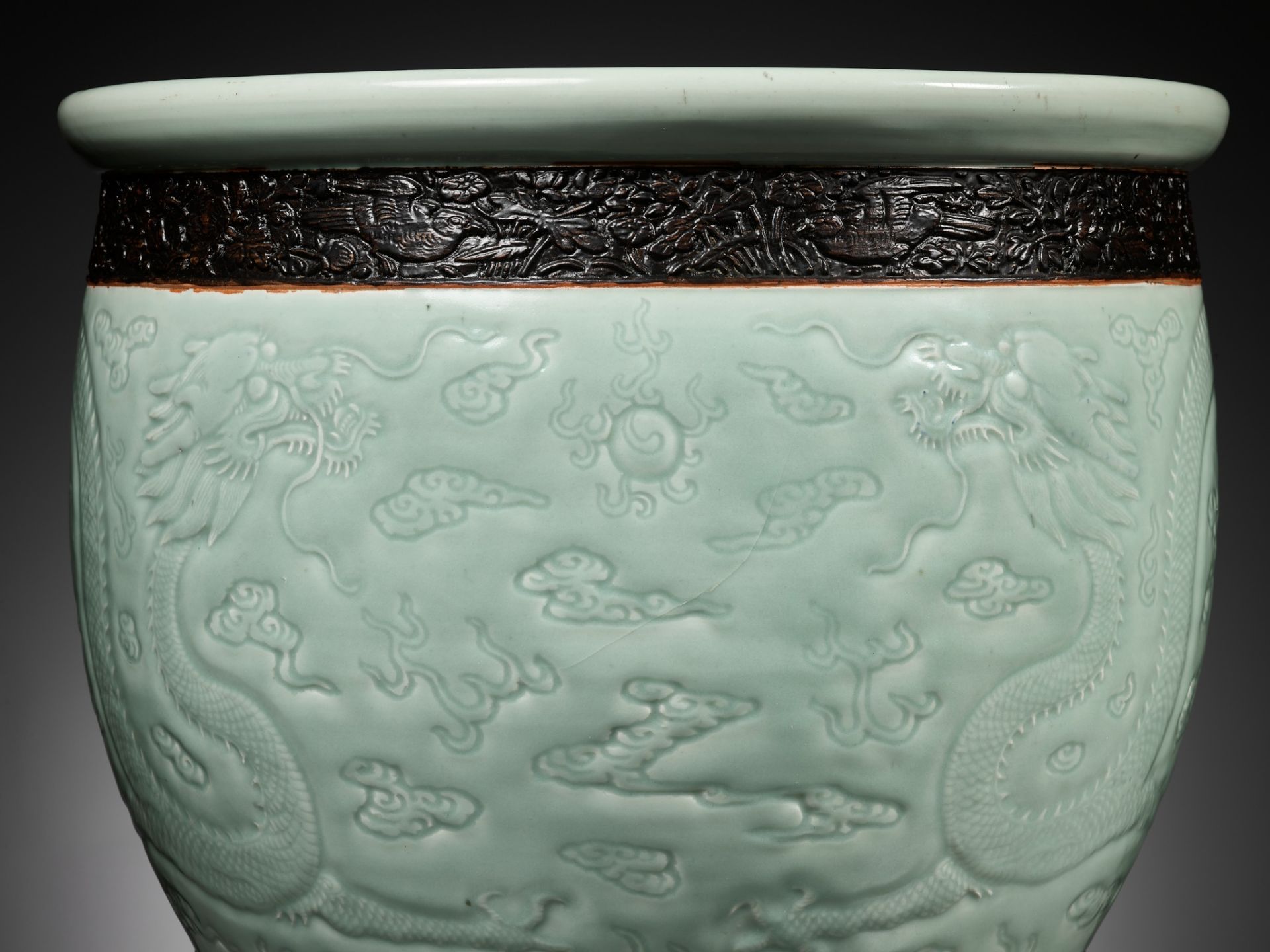A LARGE MOLDED AND CARVED CELADON-GLAZED 'DRAGON' FISHBOWL, QING DYNASTY - Image 13 of 16