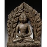 A LIMESTONE FIGURE OF BUDDHA AMITABHA UNDER THE BODHI TREE, NEPAL, 17TH-18TH CENTURY